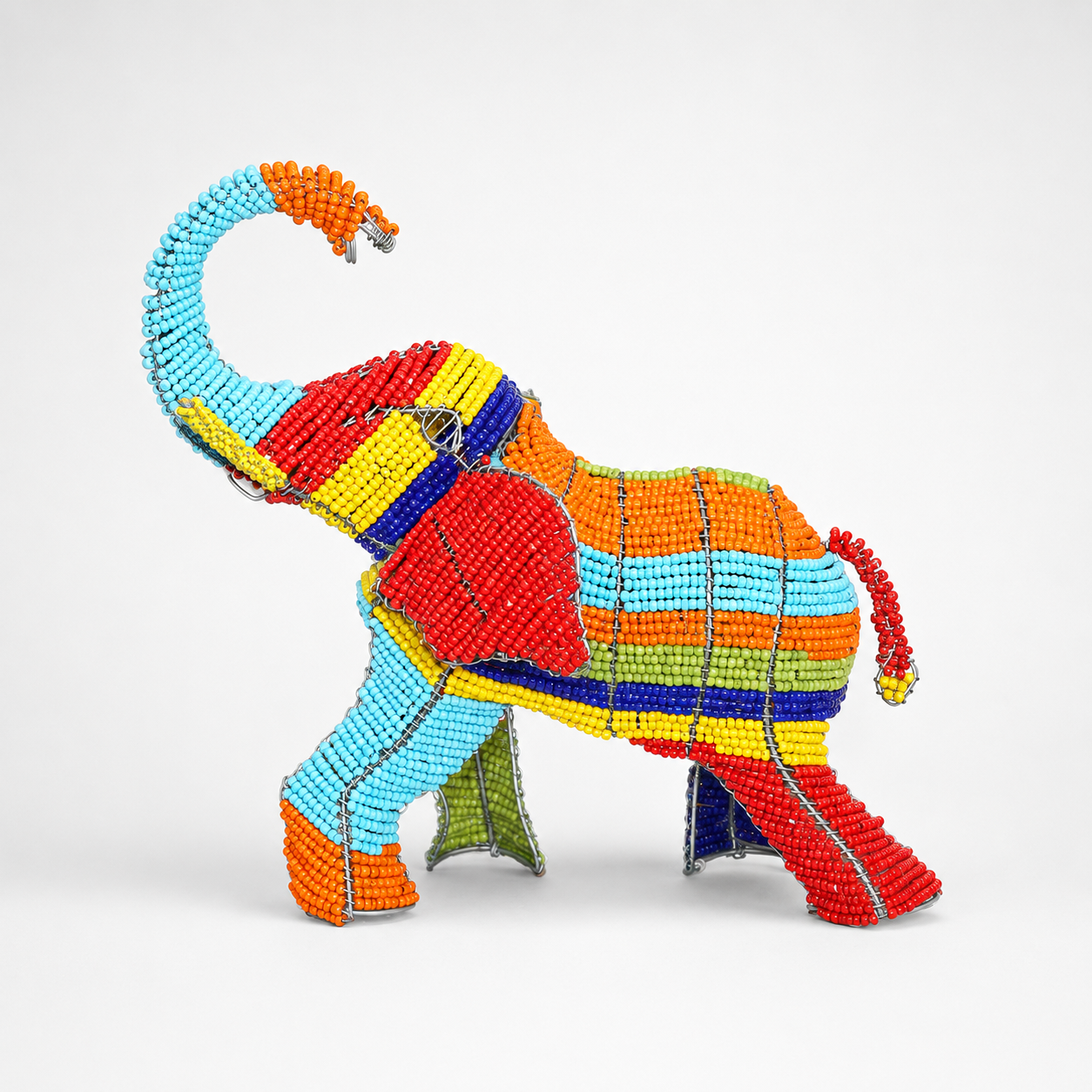 Colorful beaded elephant sculpture on a white background