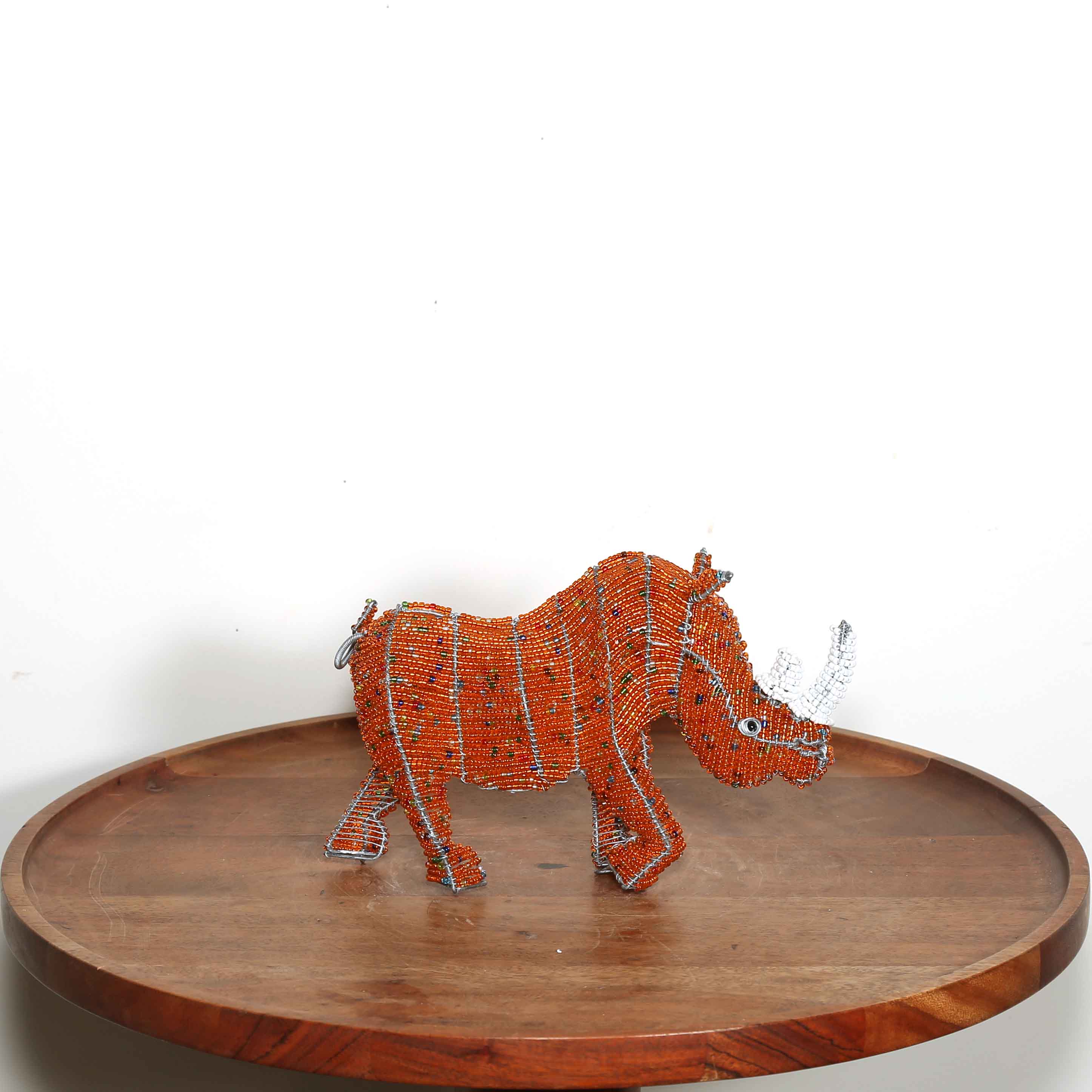 Small orange hand beaded rhino sculpture from Africa