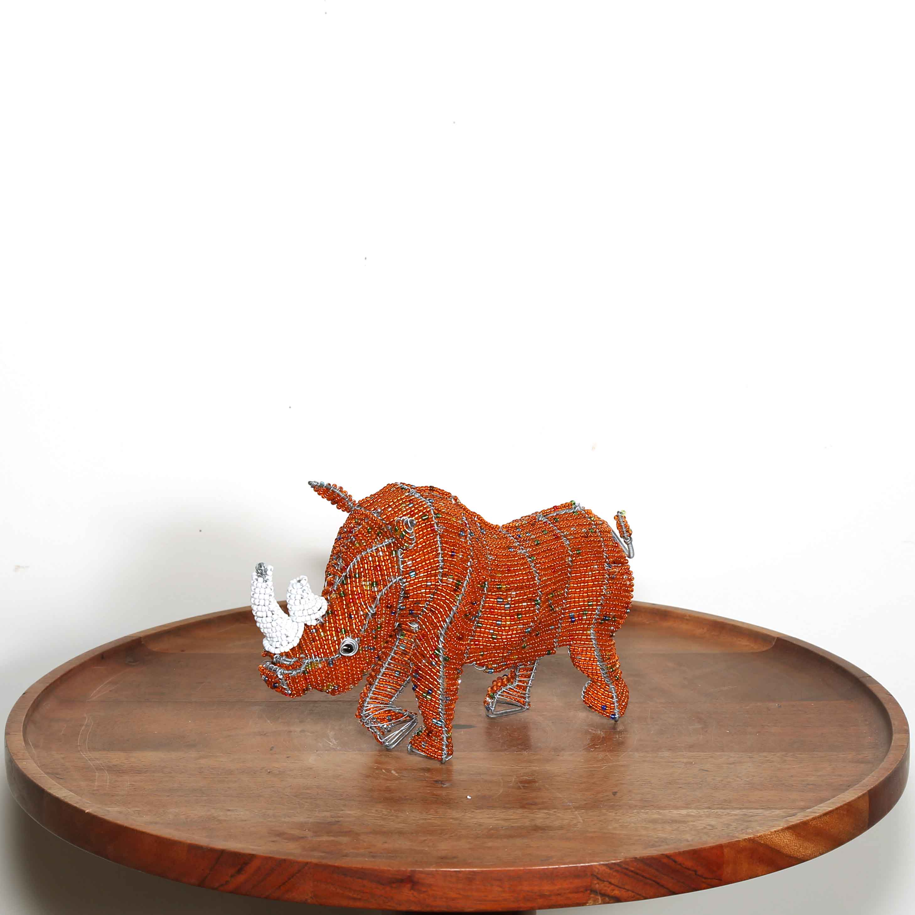 Small orange hand beaded rhino sculpture from Africa