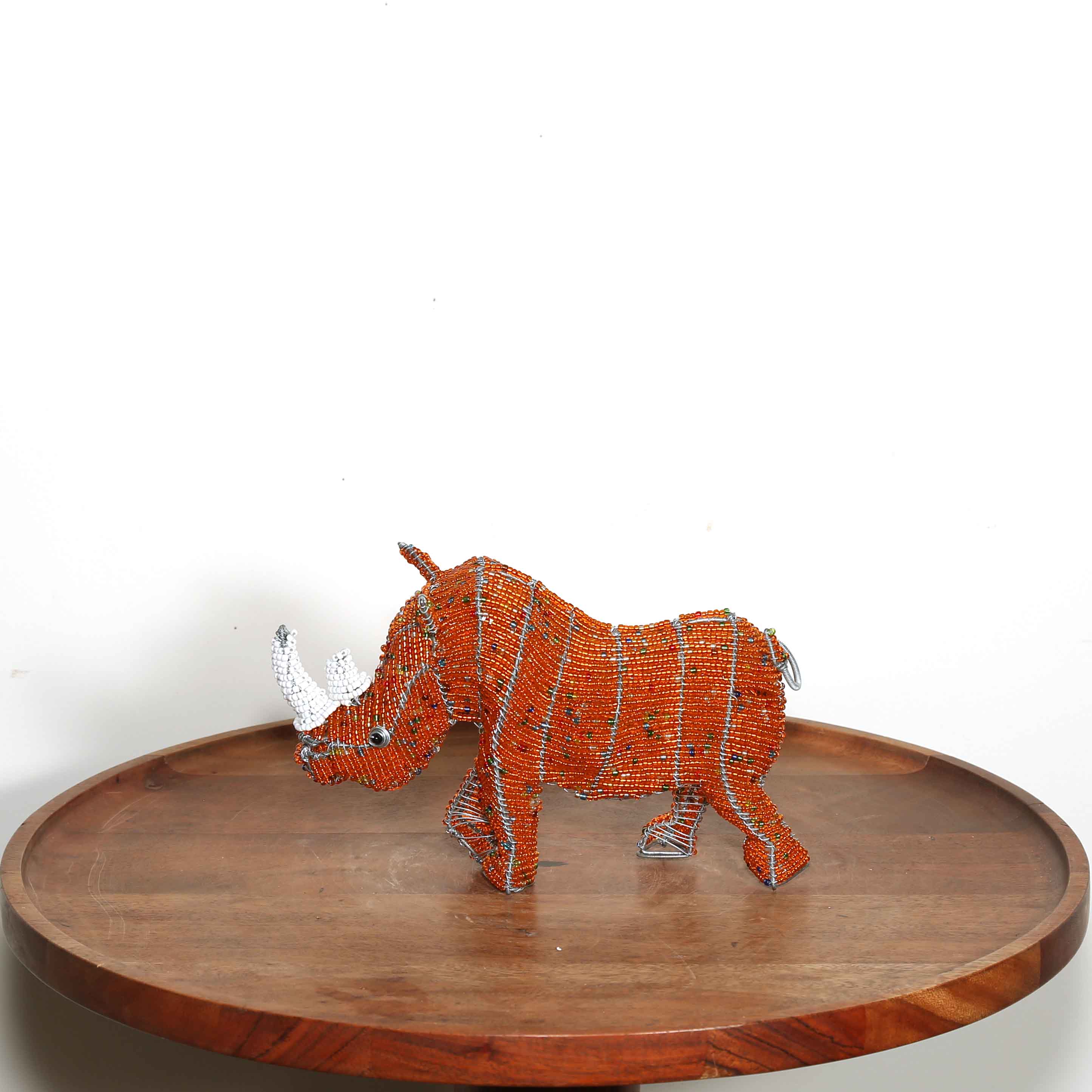 Small orange hand beaded rhino sculpture from Africa