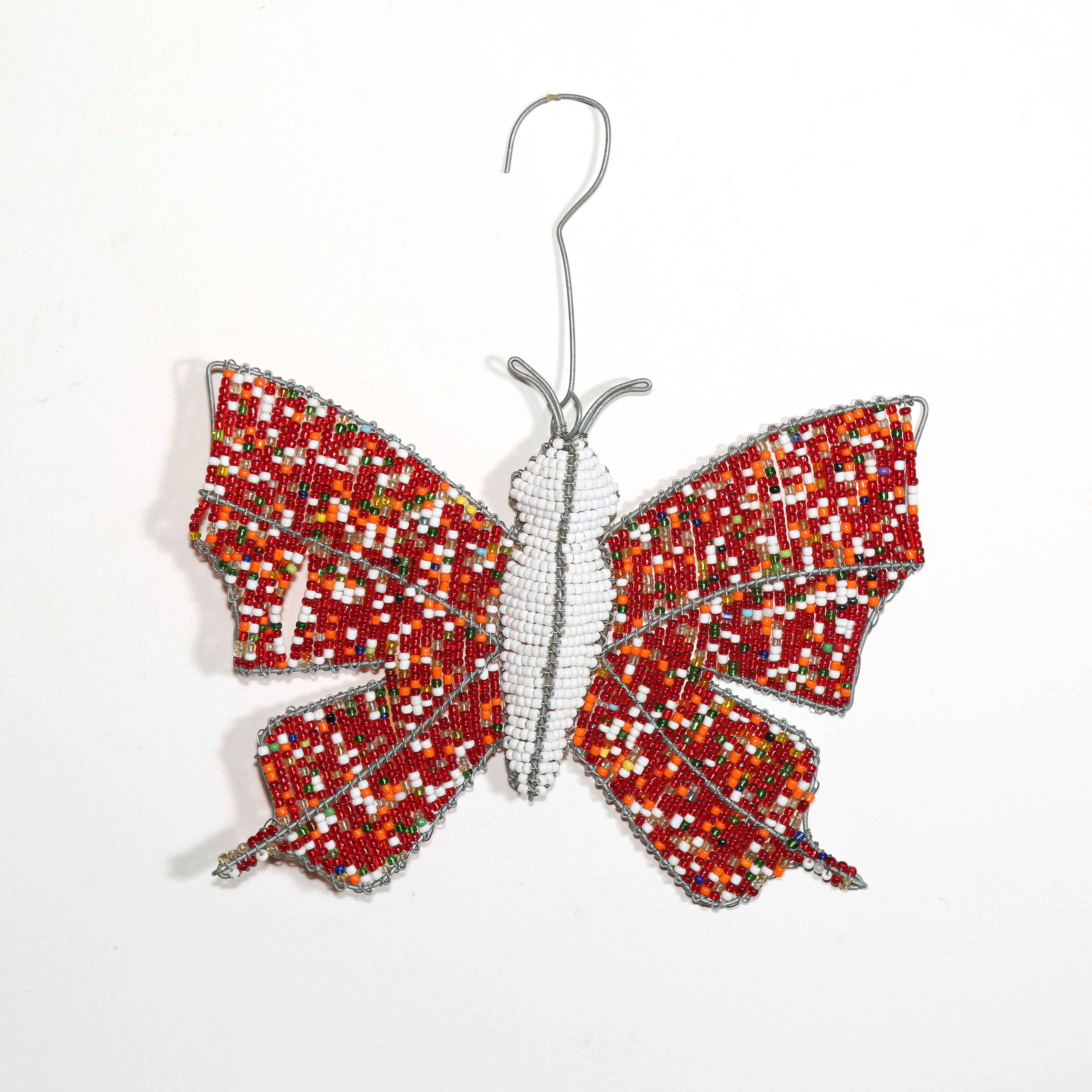 Beaded butterfly ornament with red and orange pattern on a white background
