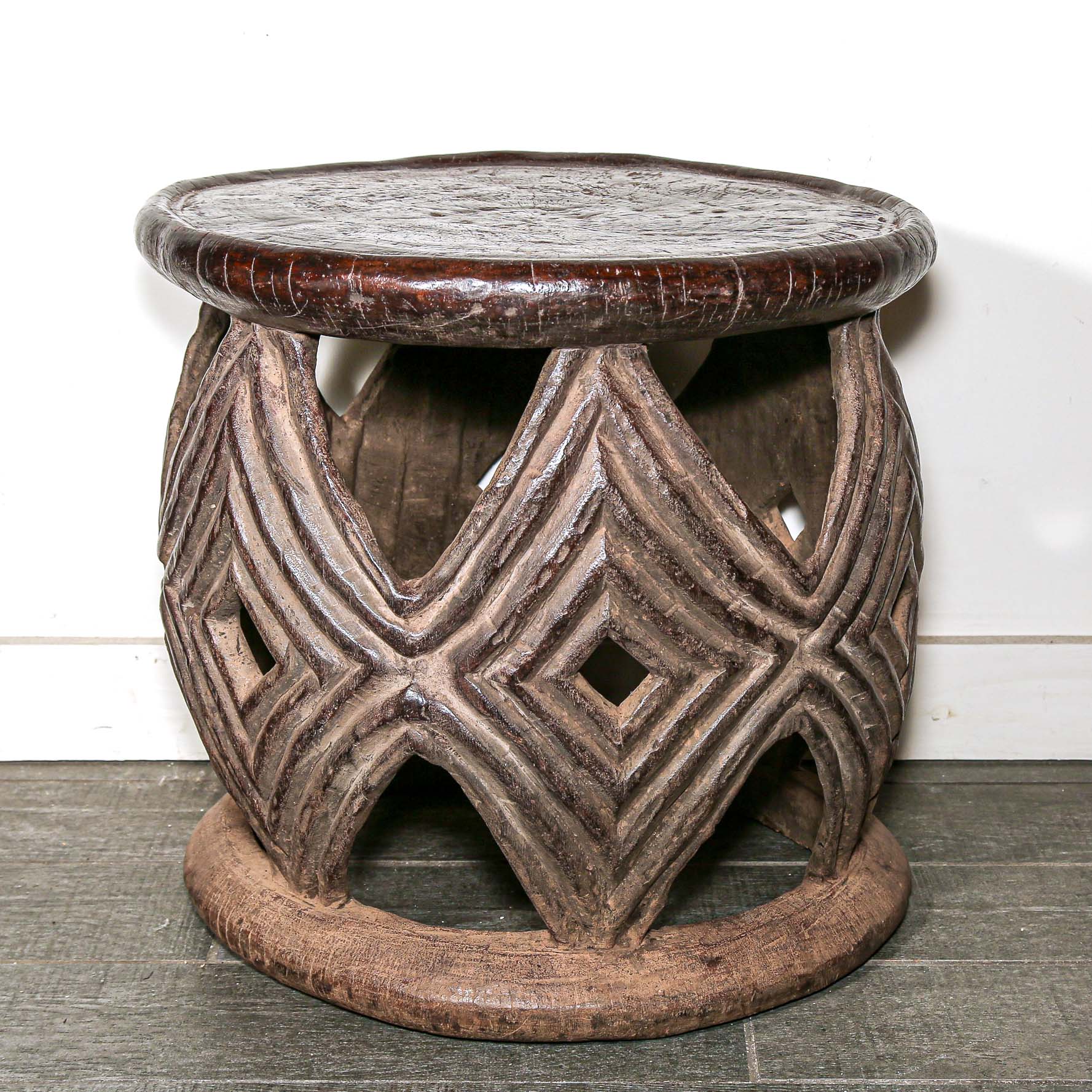 African style decor round table with geometric hand made pattern on a living room floor.