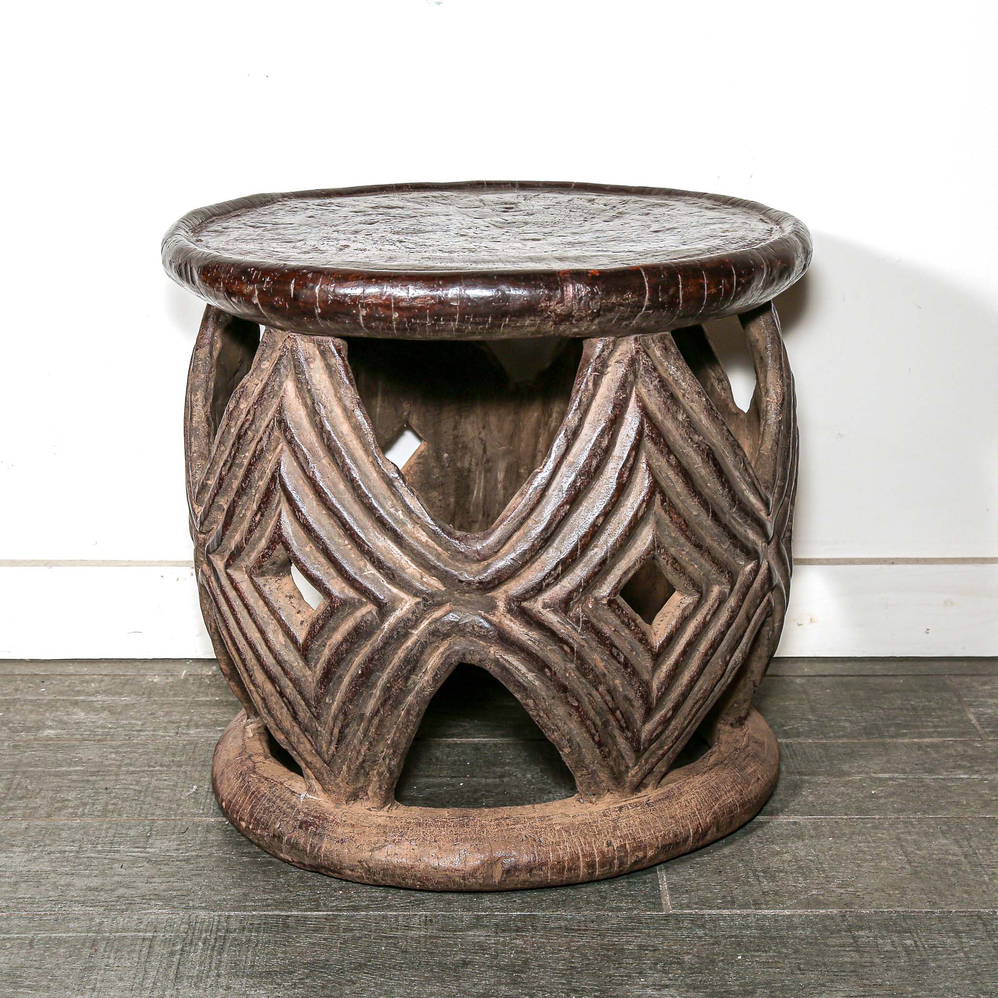 African style decor round table with geometric hand made pattern on a living room floor.