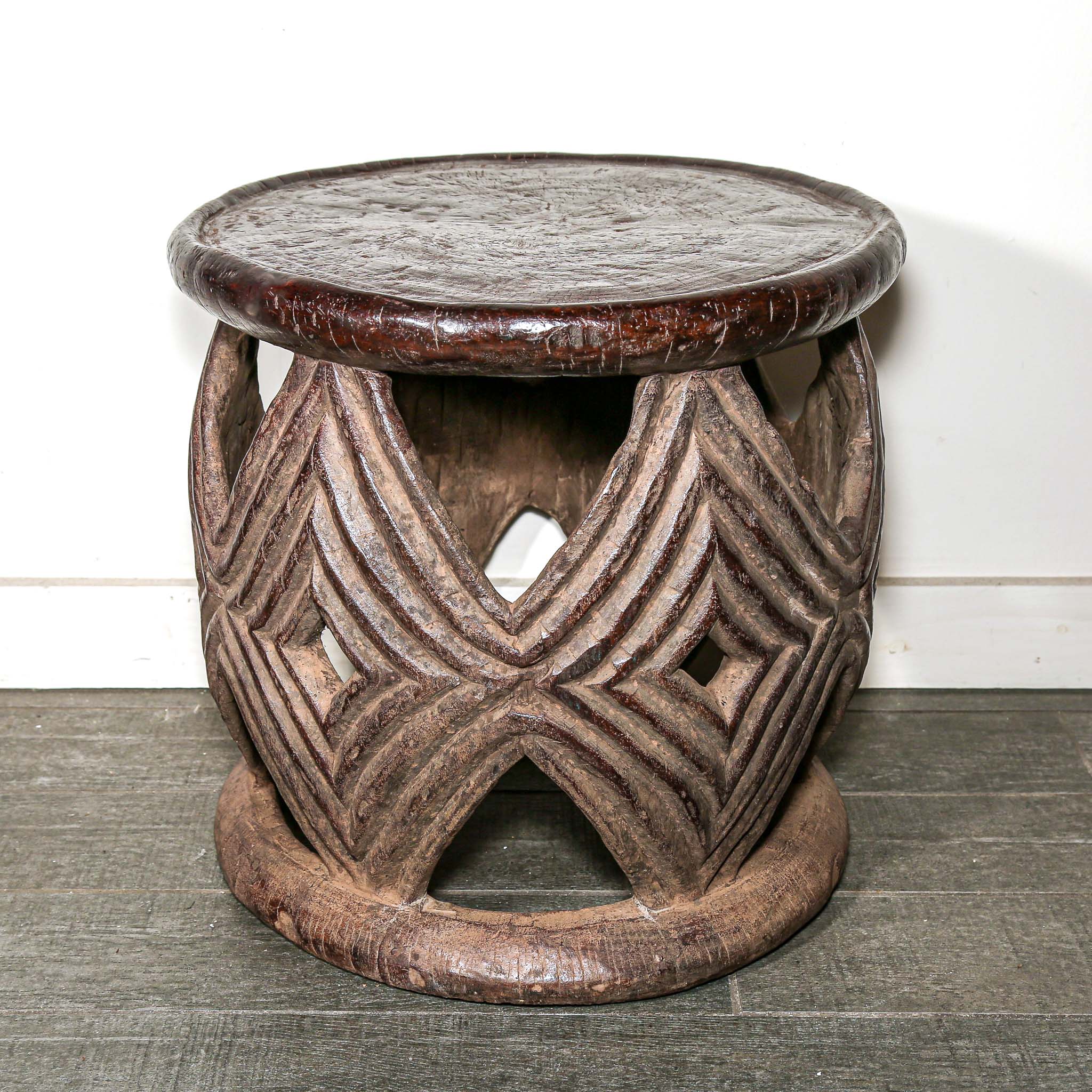 African style decor round table with geometric hand made pattern on a living room floor.