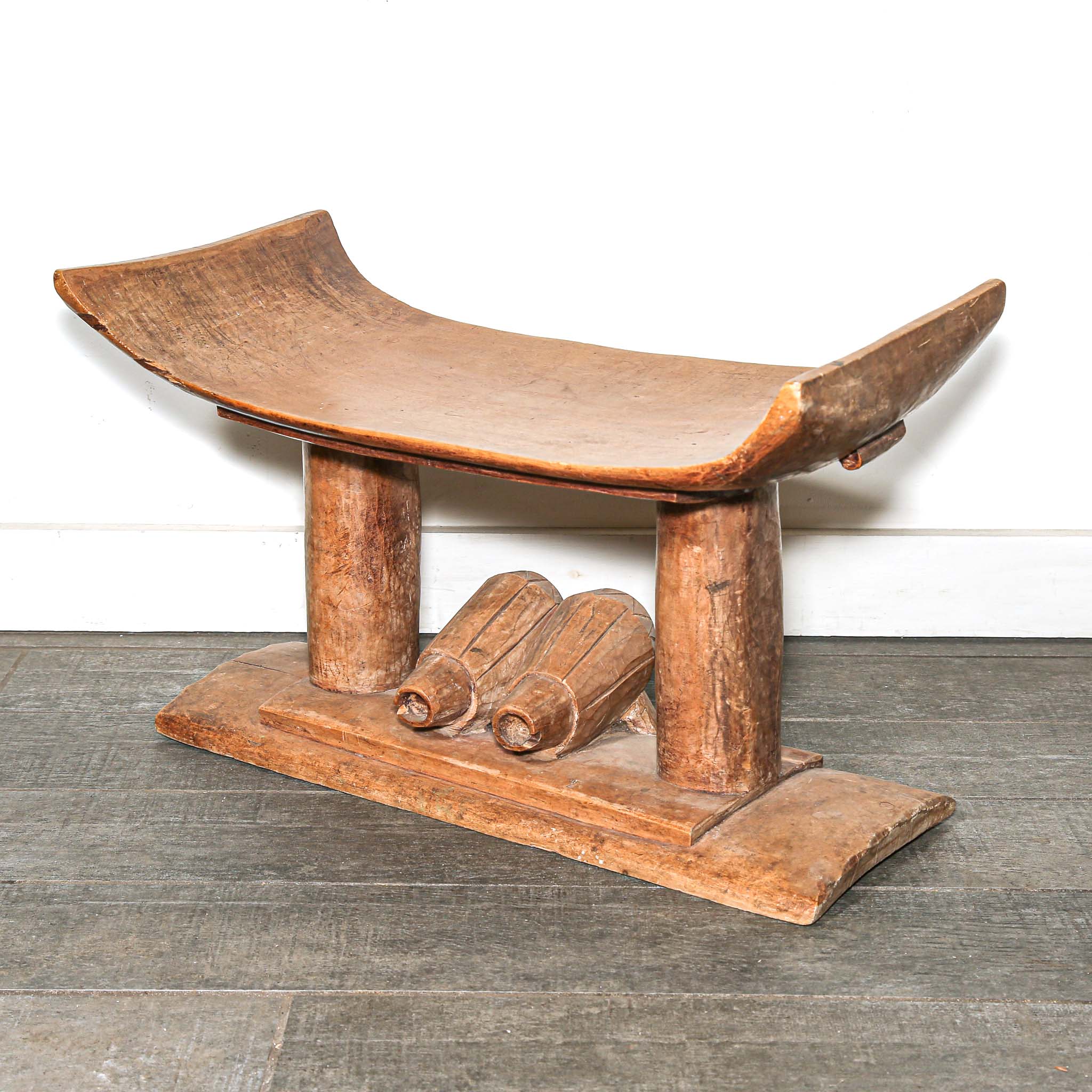 Vintage African furniture for sale. Authentic wooden stool on bed room floor