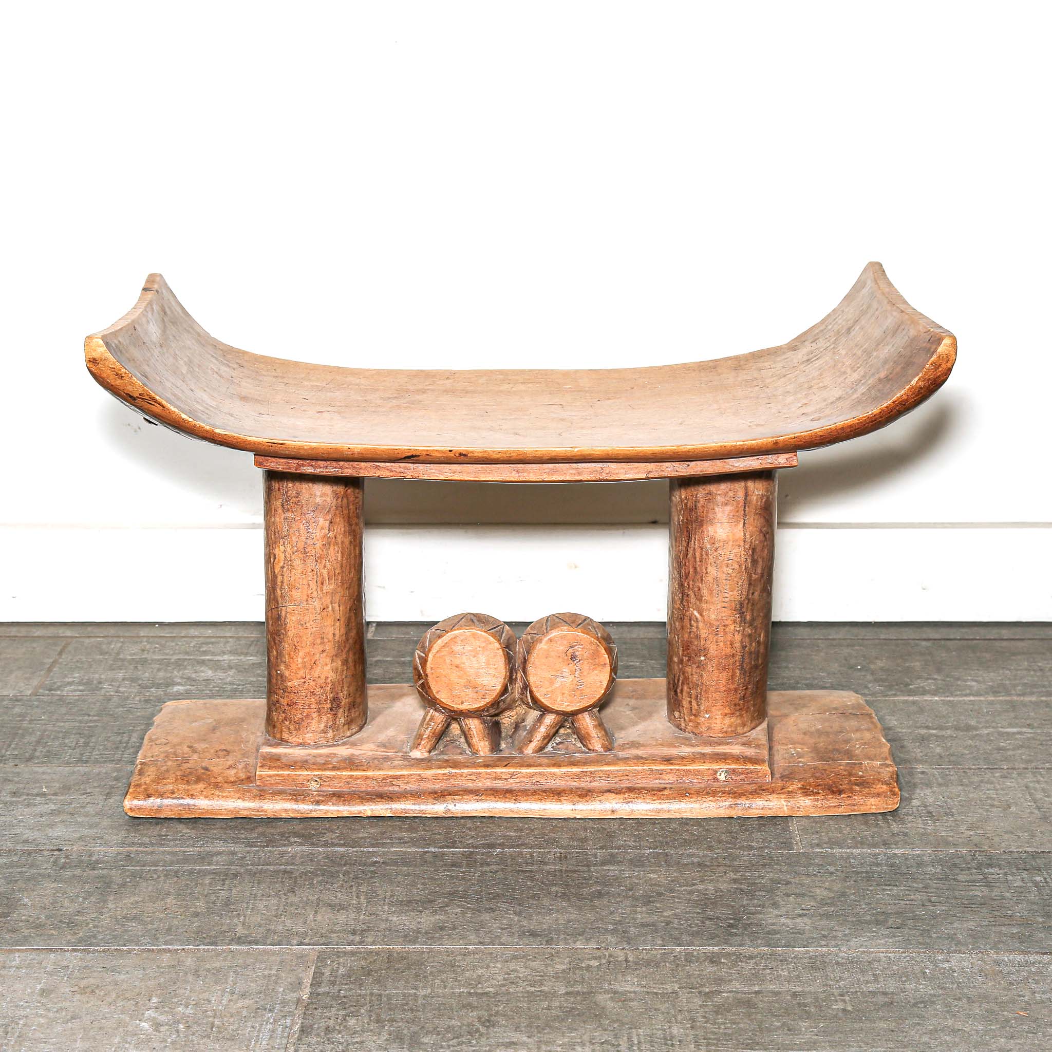 Vintage African furniture for sale. Authentic wooden stool on bed room floor