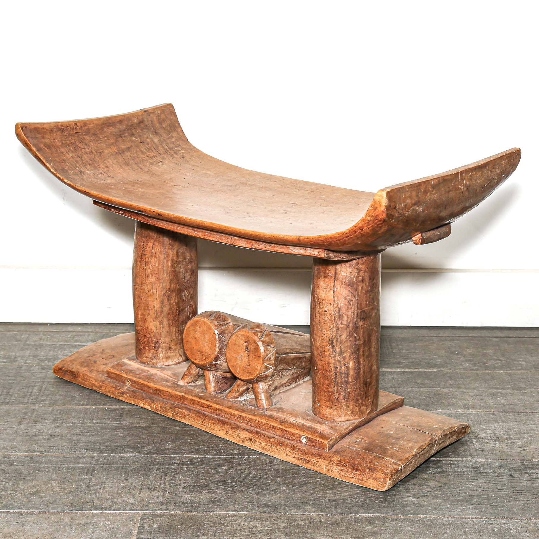 Vintage African furniture for sale. Authentic wooden stool on bed room floor