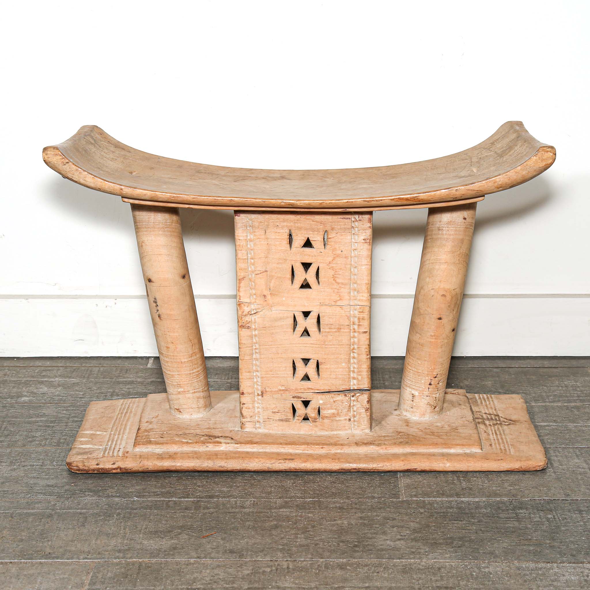 Vintage African furniture for sale. Authentic wooden stool on bed room floor