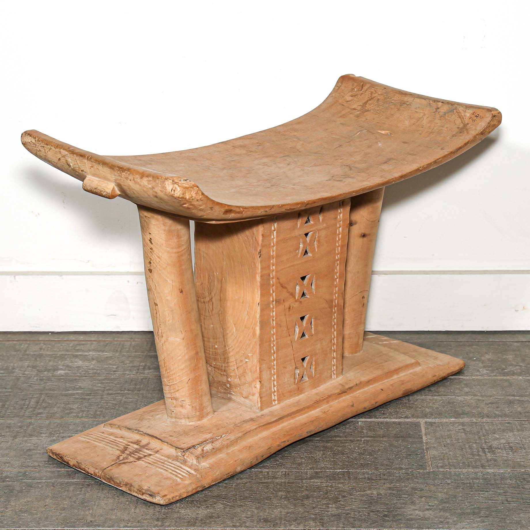 Vintage African furniture for sale. Authentic wooden stool on bed room floor