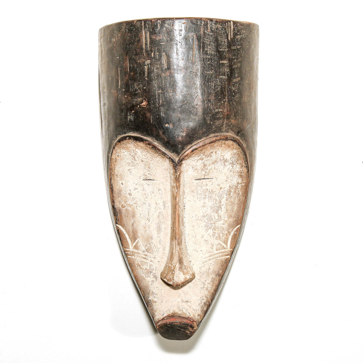Black and white Fang mask with bold carved facial features and striking Central African tribal art styling