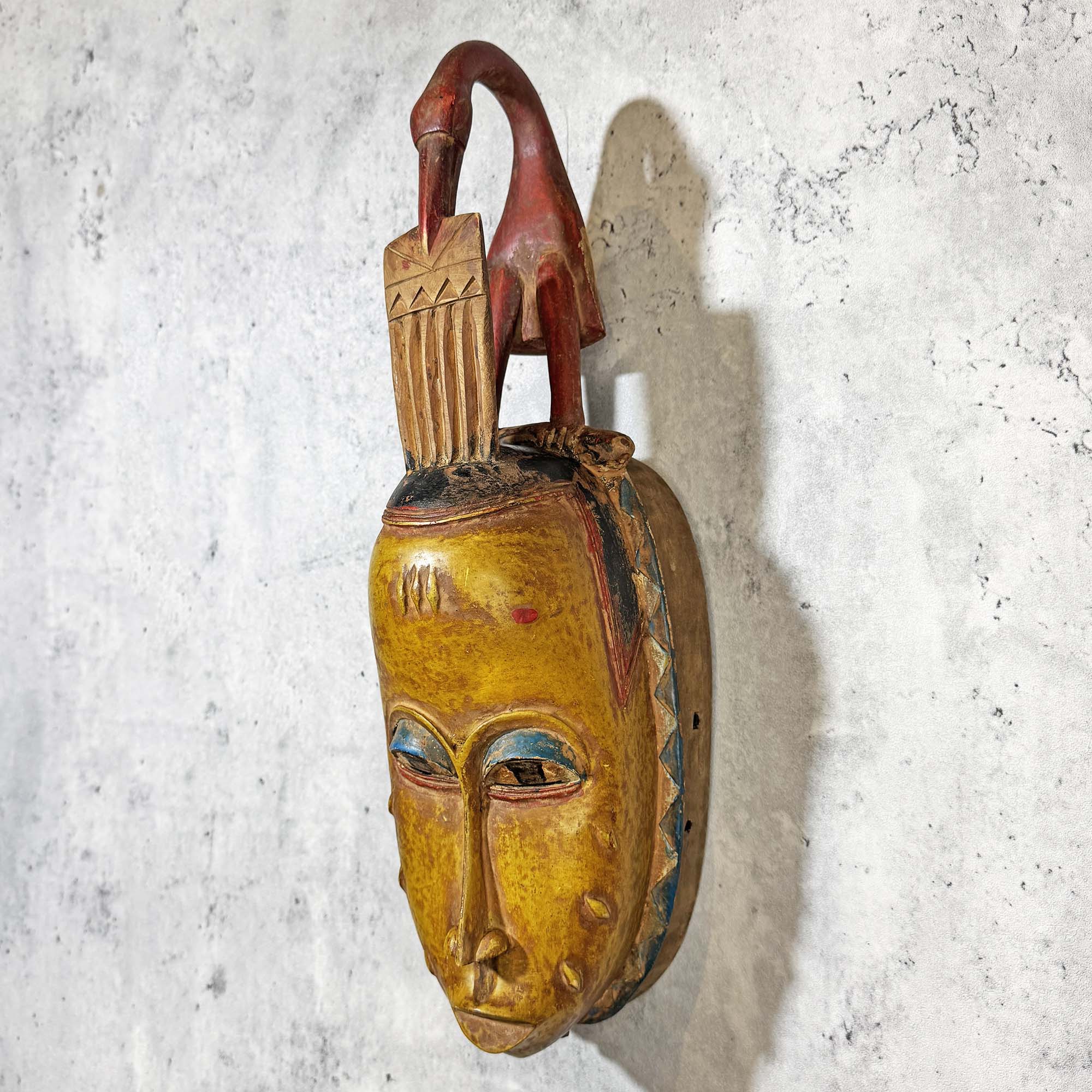 Guro Mask from Côte d'Ivoire in Yellow-Red as an African mask wall decor idea