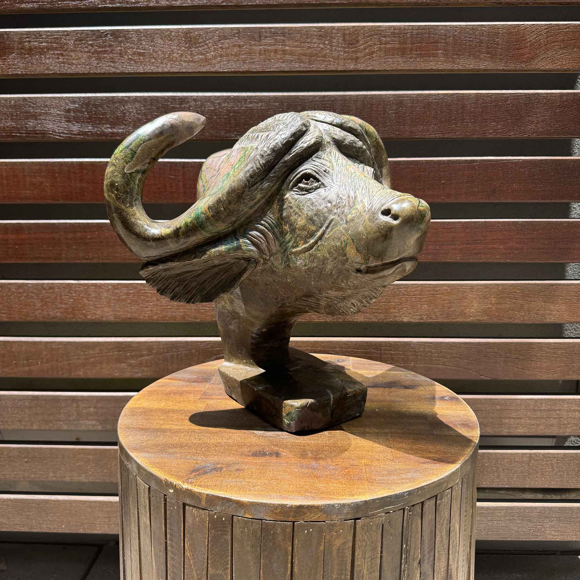 Sculpture of a buffalo from the front. In hand carved and handmade stone