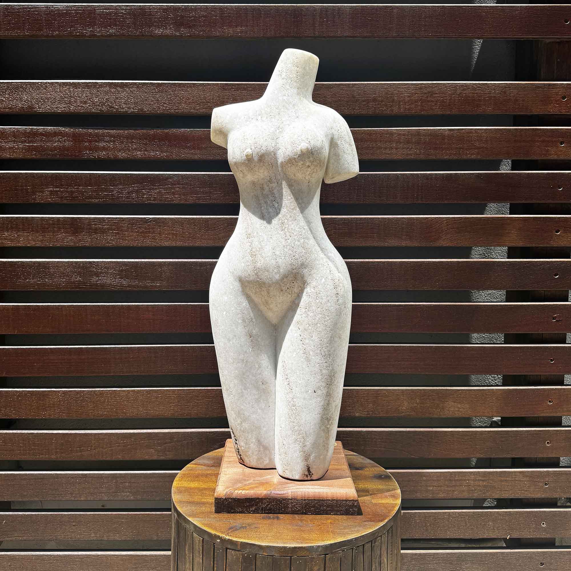 white stone statue of a woman placed outside