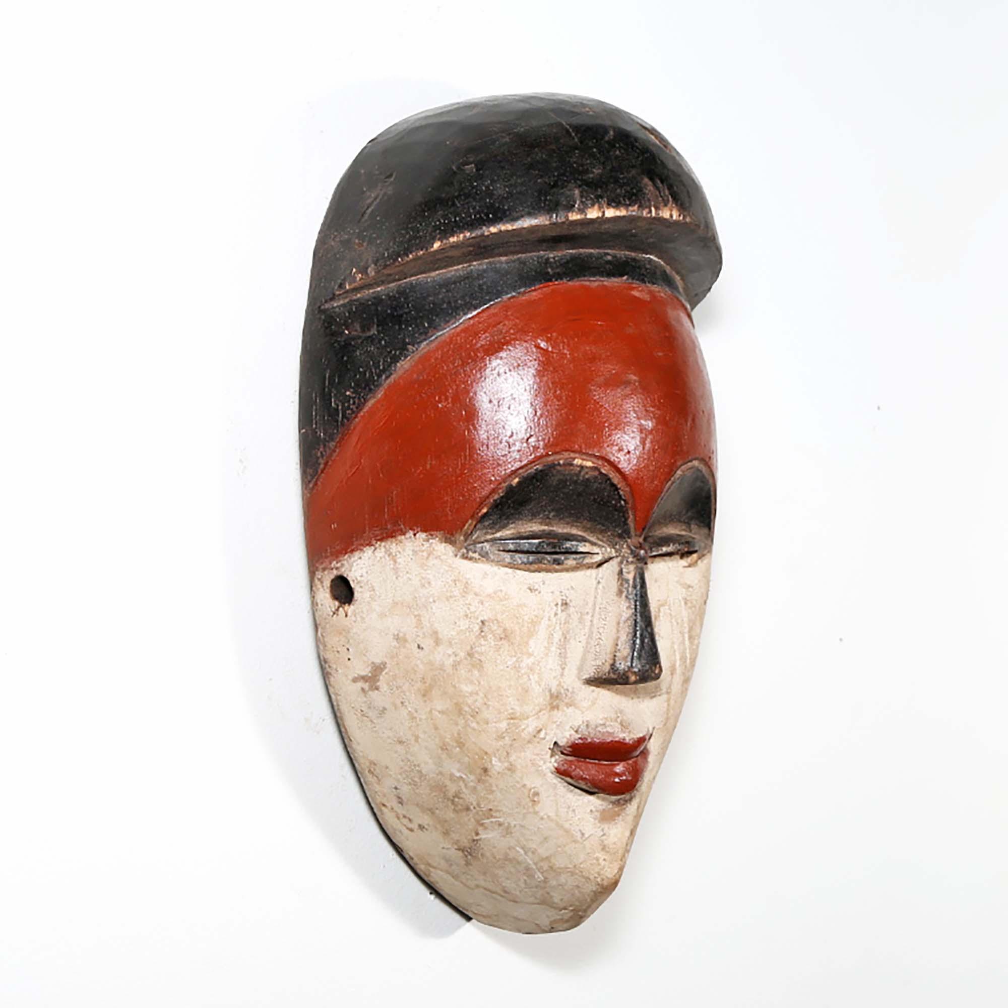 Igbo Style African Mask from Nigeria in red as a wall decoration right side