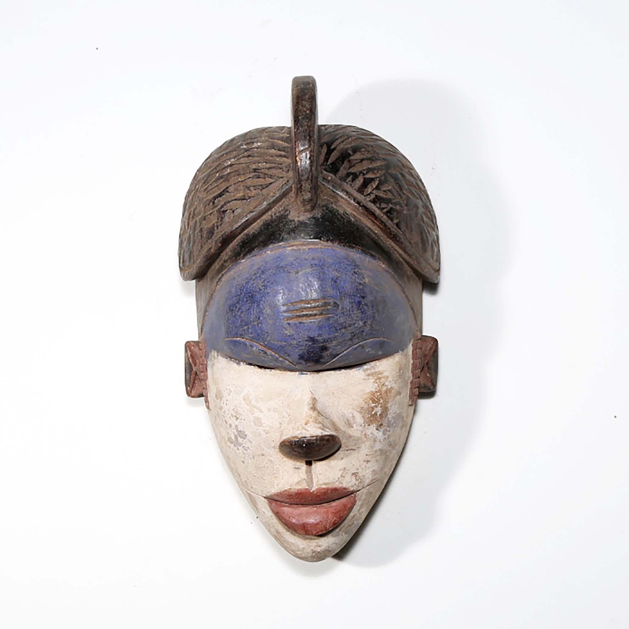 Igbo Style African Mask from Nigeria in blue as a wall decor idea in front