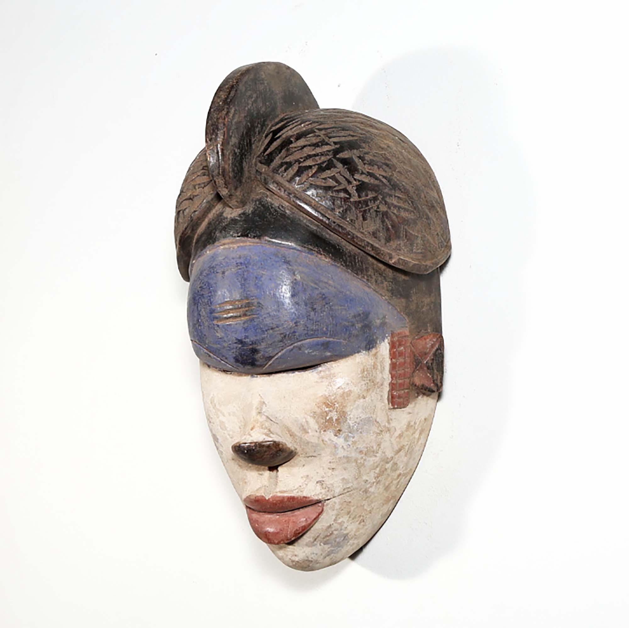 Igbo Style African Mask from Nigeria in blue as a wall decor idea left side