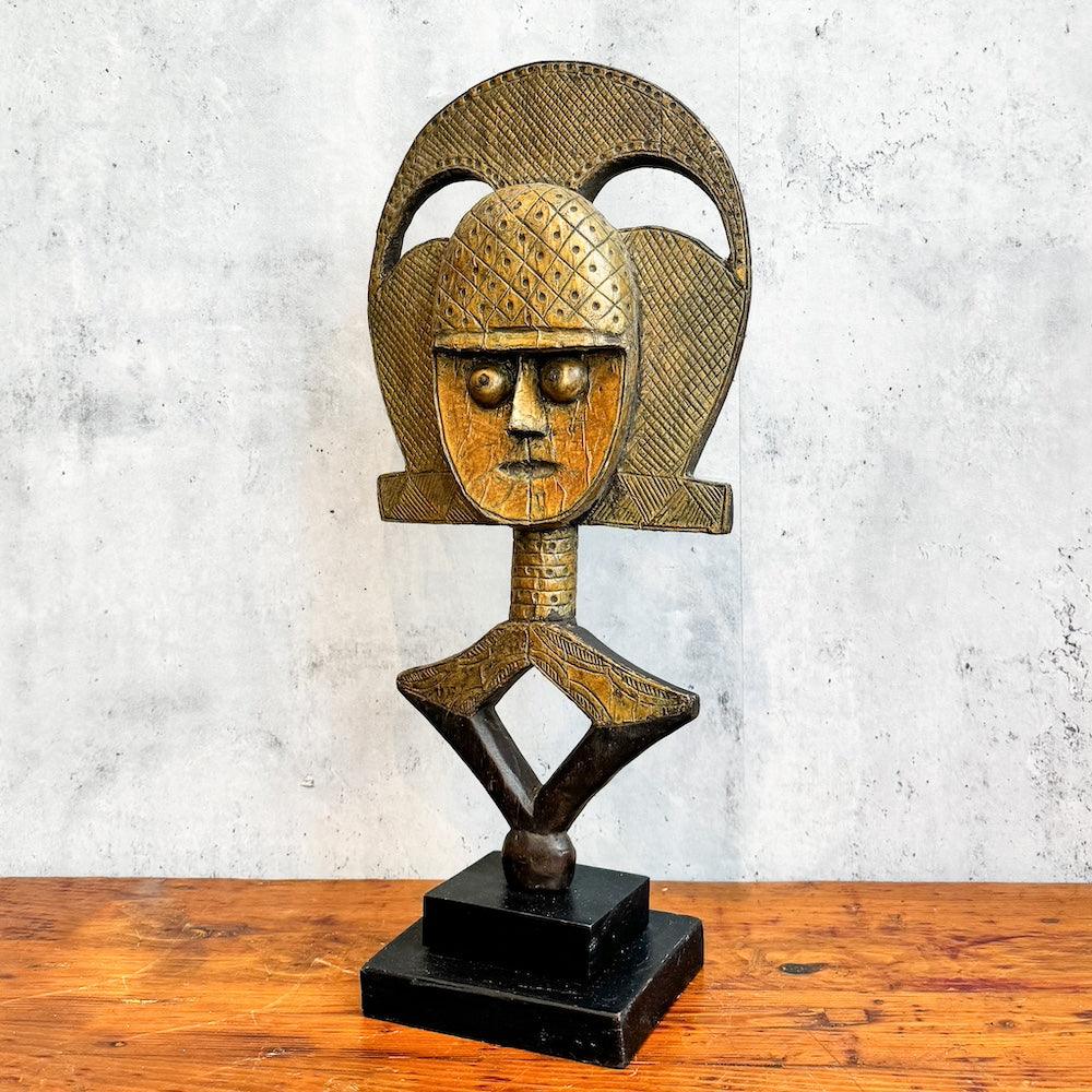 Kota Reliquary Guardian Figure from Gabon standing on a table showing left side