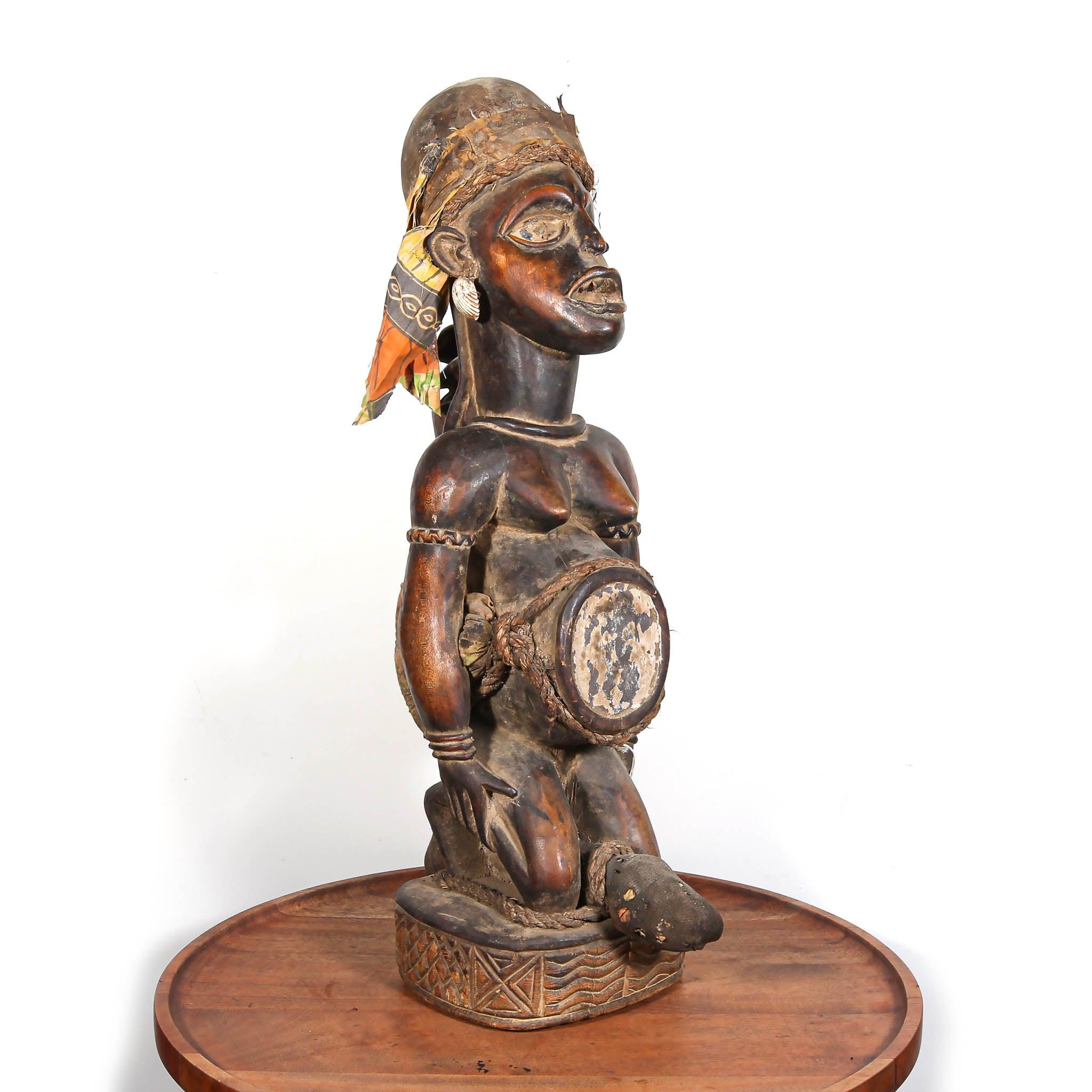 Handmade Kuba Power Figure from D.R. Congo skewed on a table