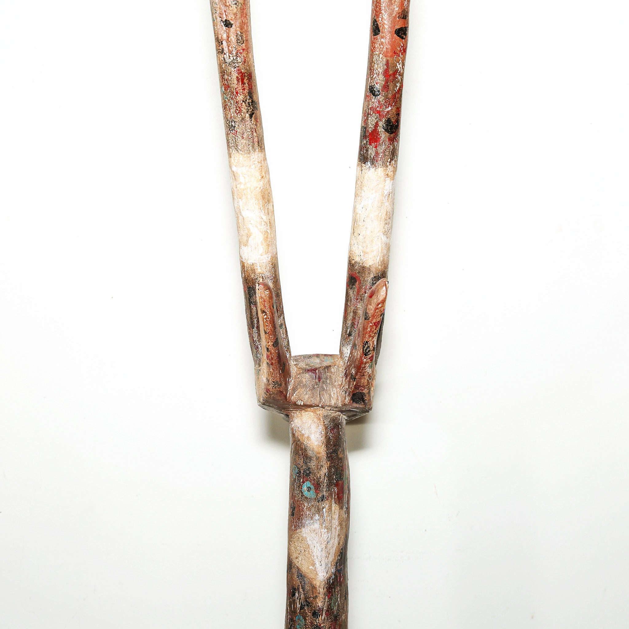 A handcrafted wooden African tribal amsk featuring natural wood grain, weathered white paint, and hand-painted red and black accents, set against a plain white background.