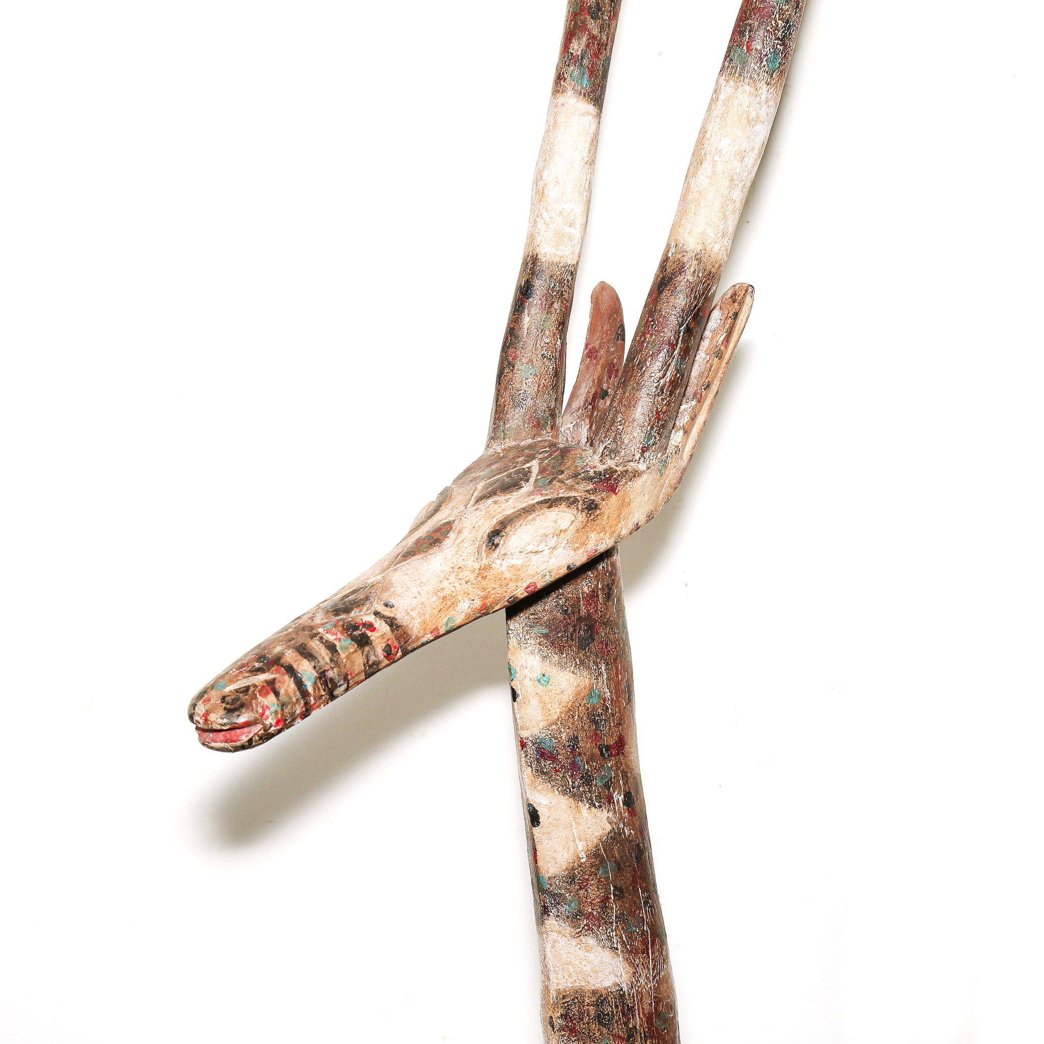 A hand-carved wooden Africa ceremonial art, painted with earthy brown, beige, and red patterns, set against a plain white background.