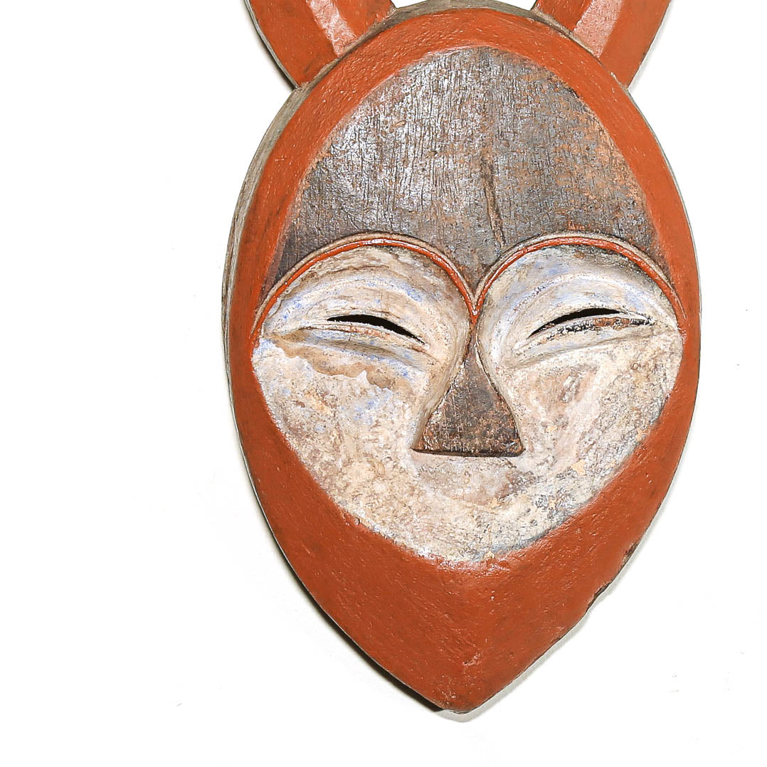 A hand-painted wooden fox head pendant or wall hanging, featuring a terracotta orange-brown painted finish with a weathered silver-gray and off-white textured face, shown against a plain white background.