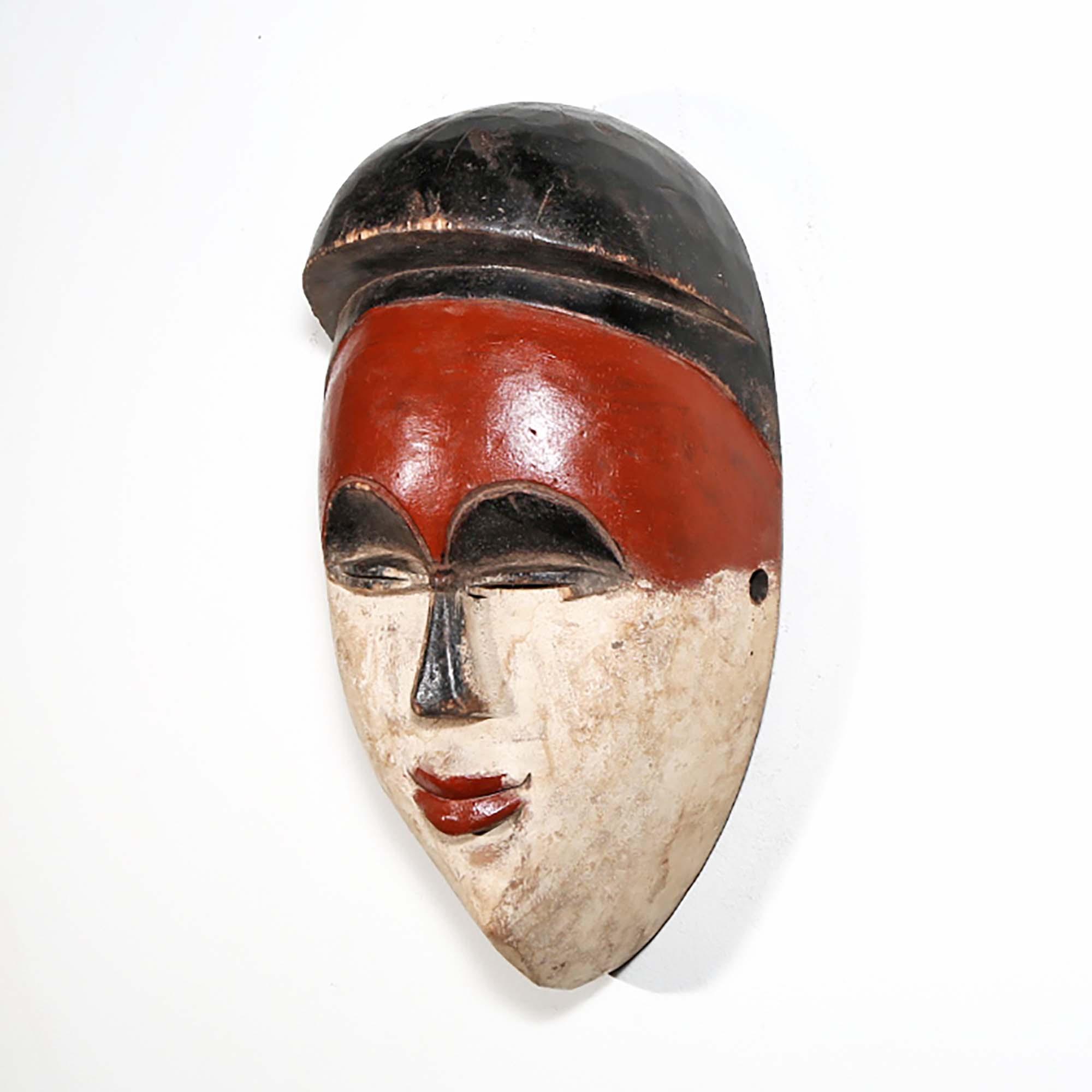 In the cultures of the Luba and Songye, a mask is known as a kifwebe, a term designated for African masks embodying spirits and distinguished by grooved patterns. Kifwebe masks, traditionally performed in rites of passage, were invoked by community heads to maintain harmony and used as a safeguard against malevolent spirits. This mask, while reflecting the essence of those historical pieces, is a modern decorative art piece.