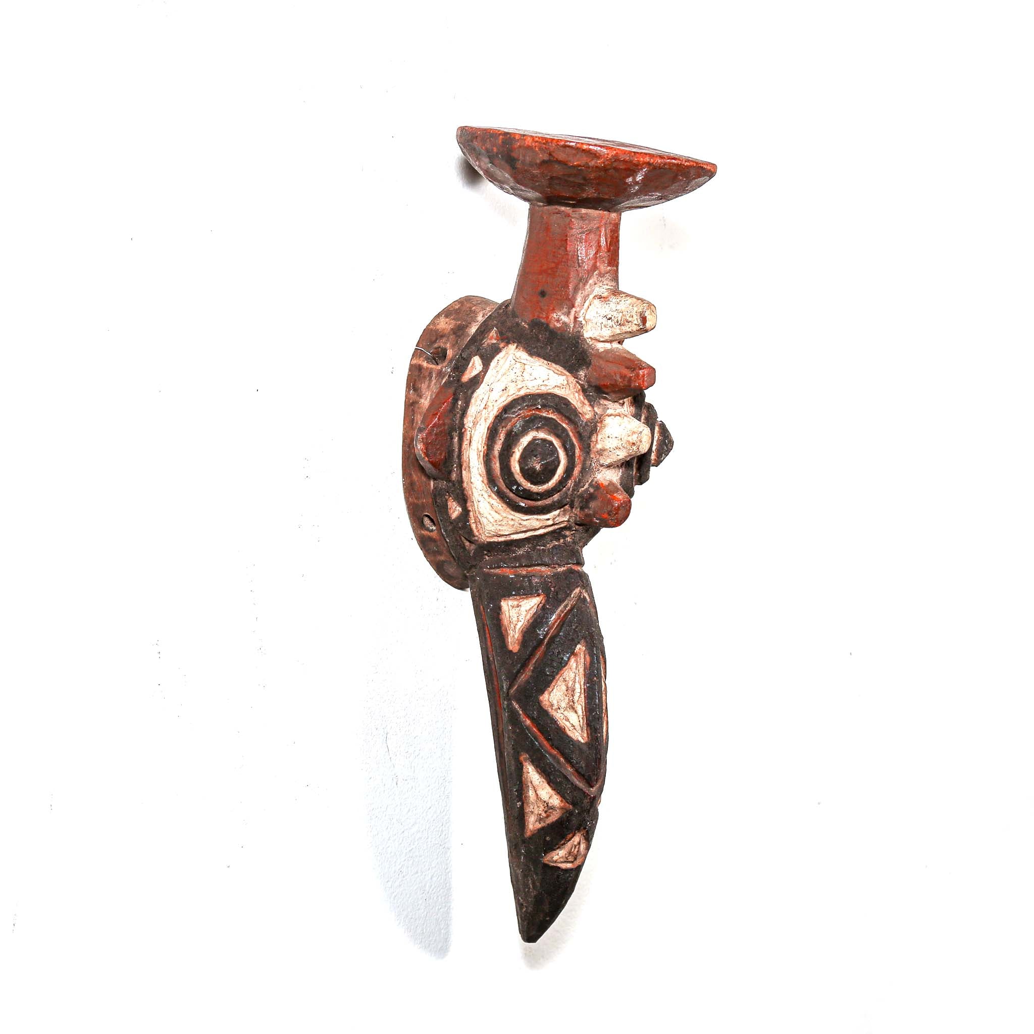 hand made carved wood bird-shaped mask with intricate designs on a white background