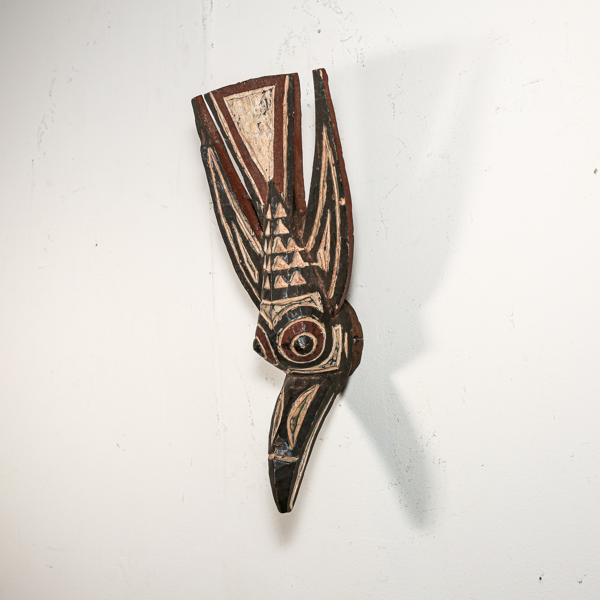 Authentic Wooden African mask with intricate designs on a white background