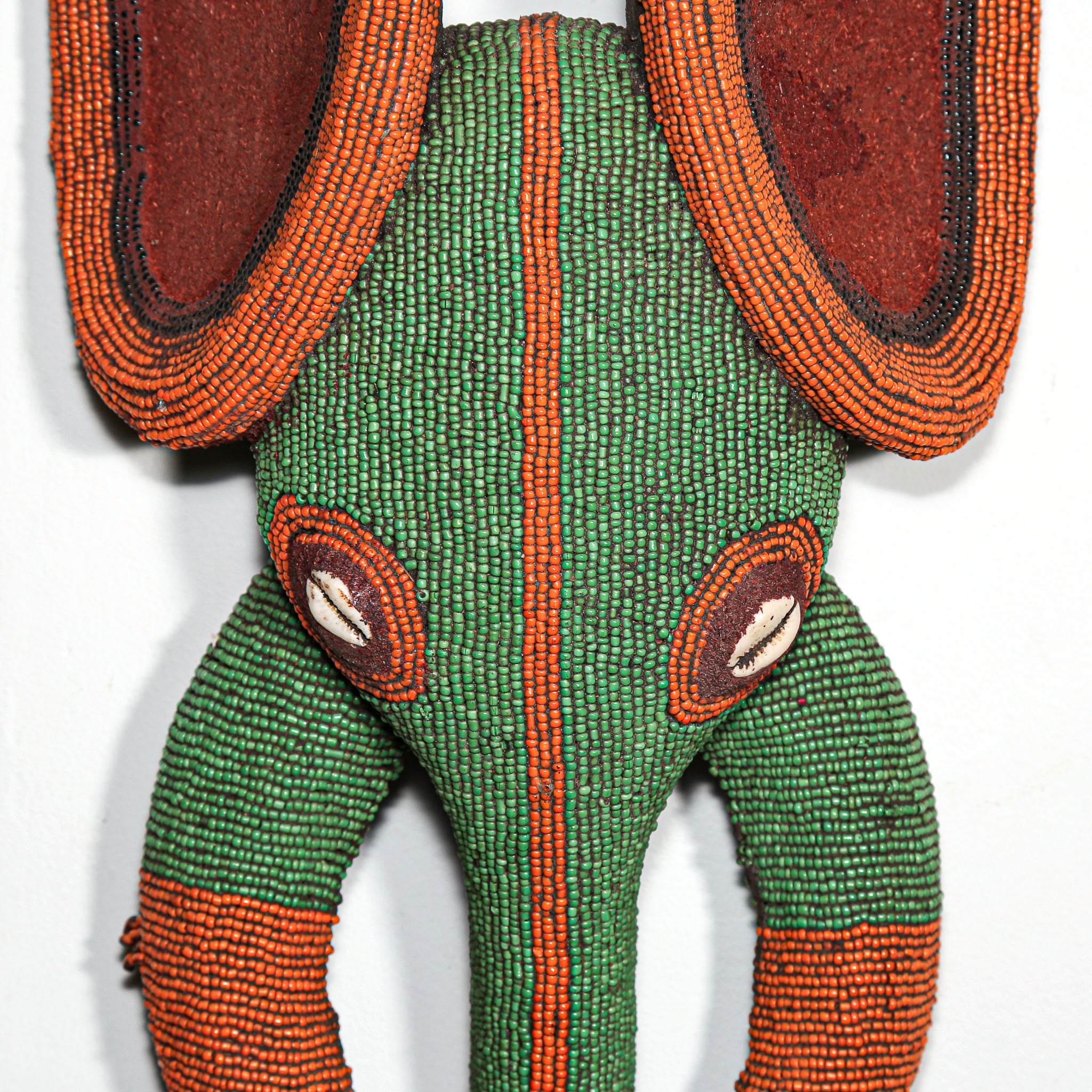 green and orange beads on African mask