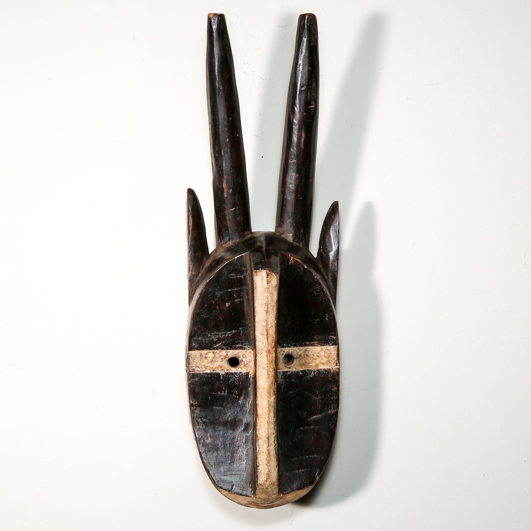 wood mask in the shape of an animal