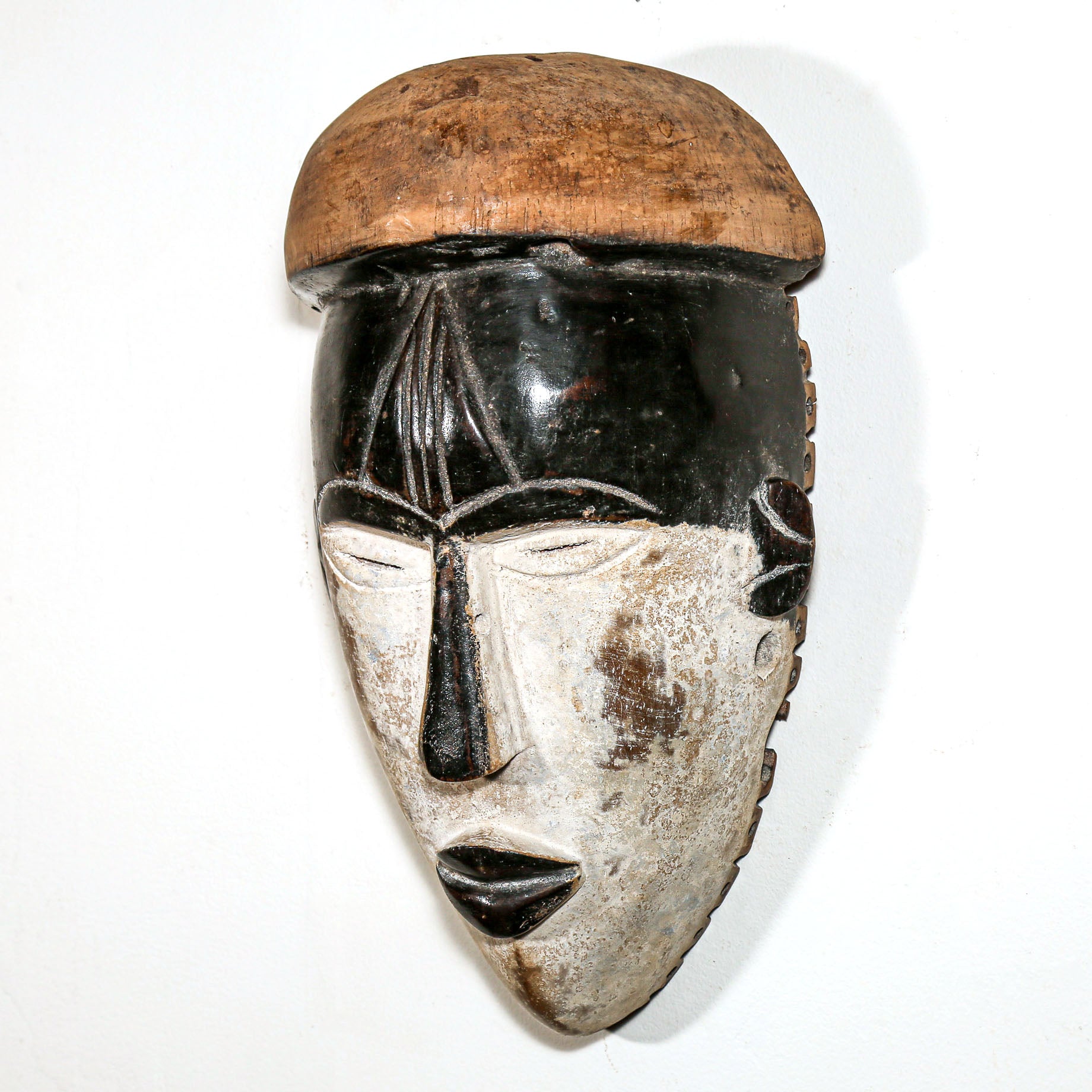 side view of painted african wood mask