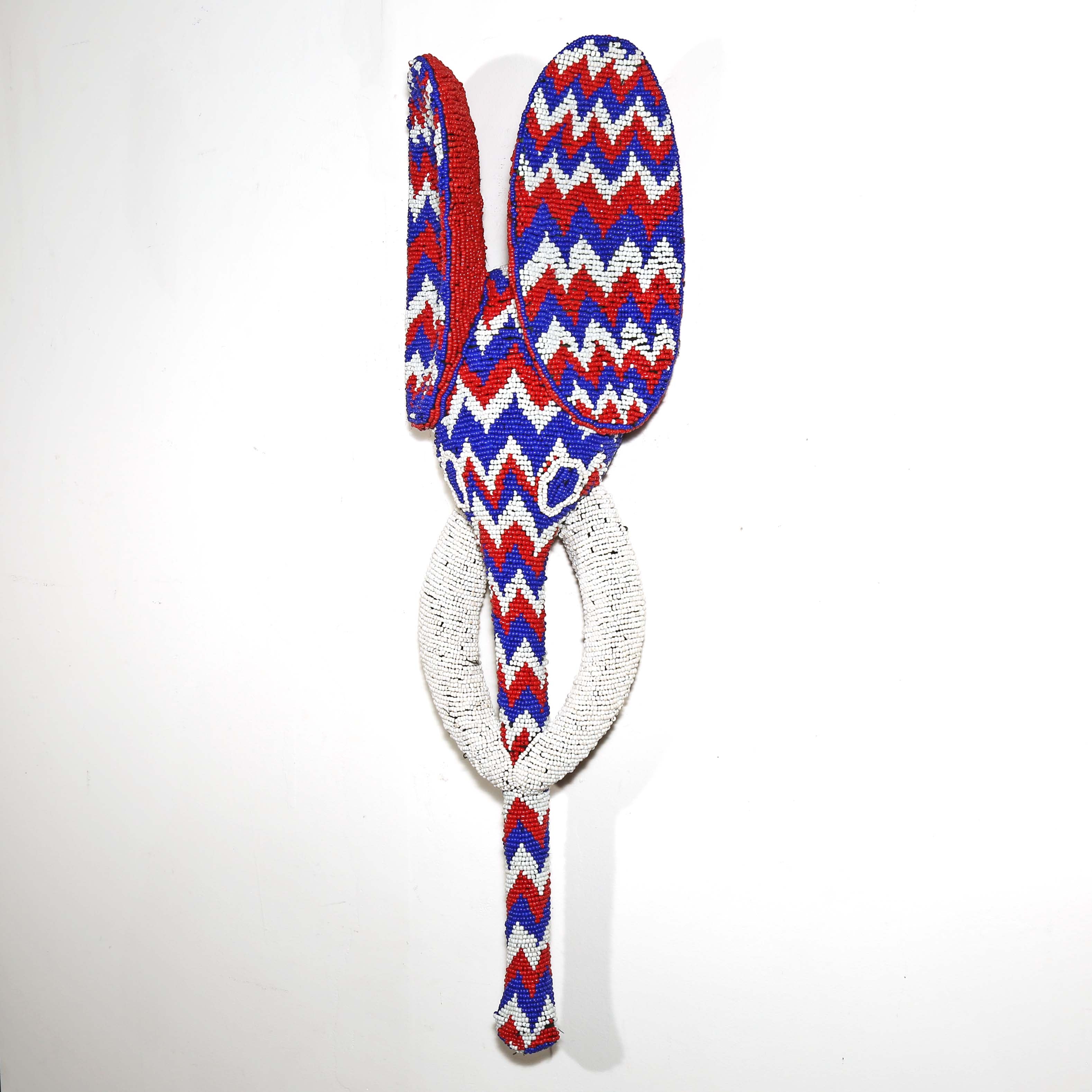wooden elephant display mask covered in colorful beads