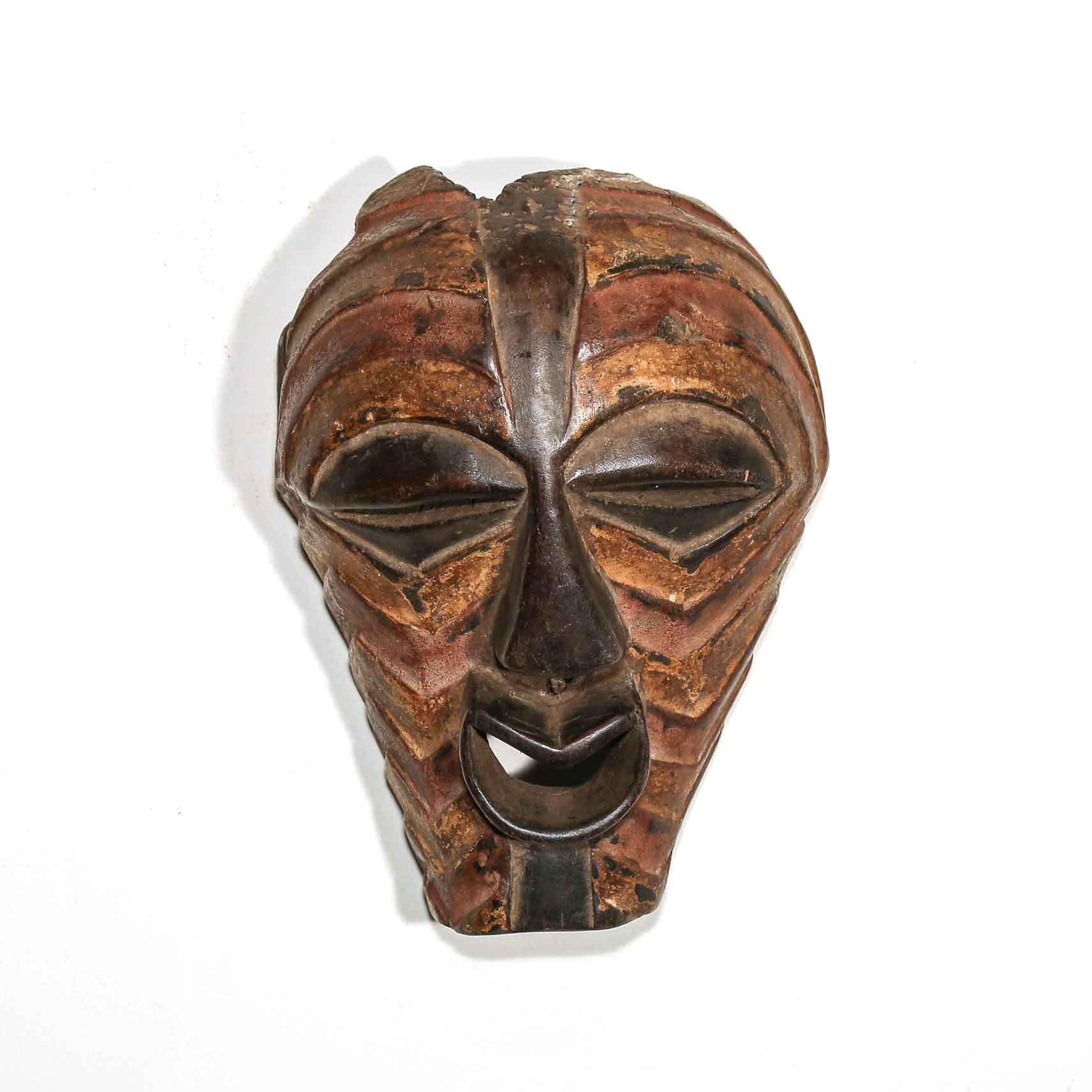 Wooden African mask with a white background