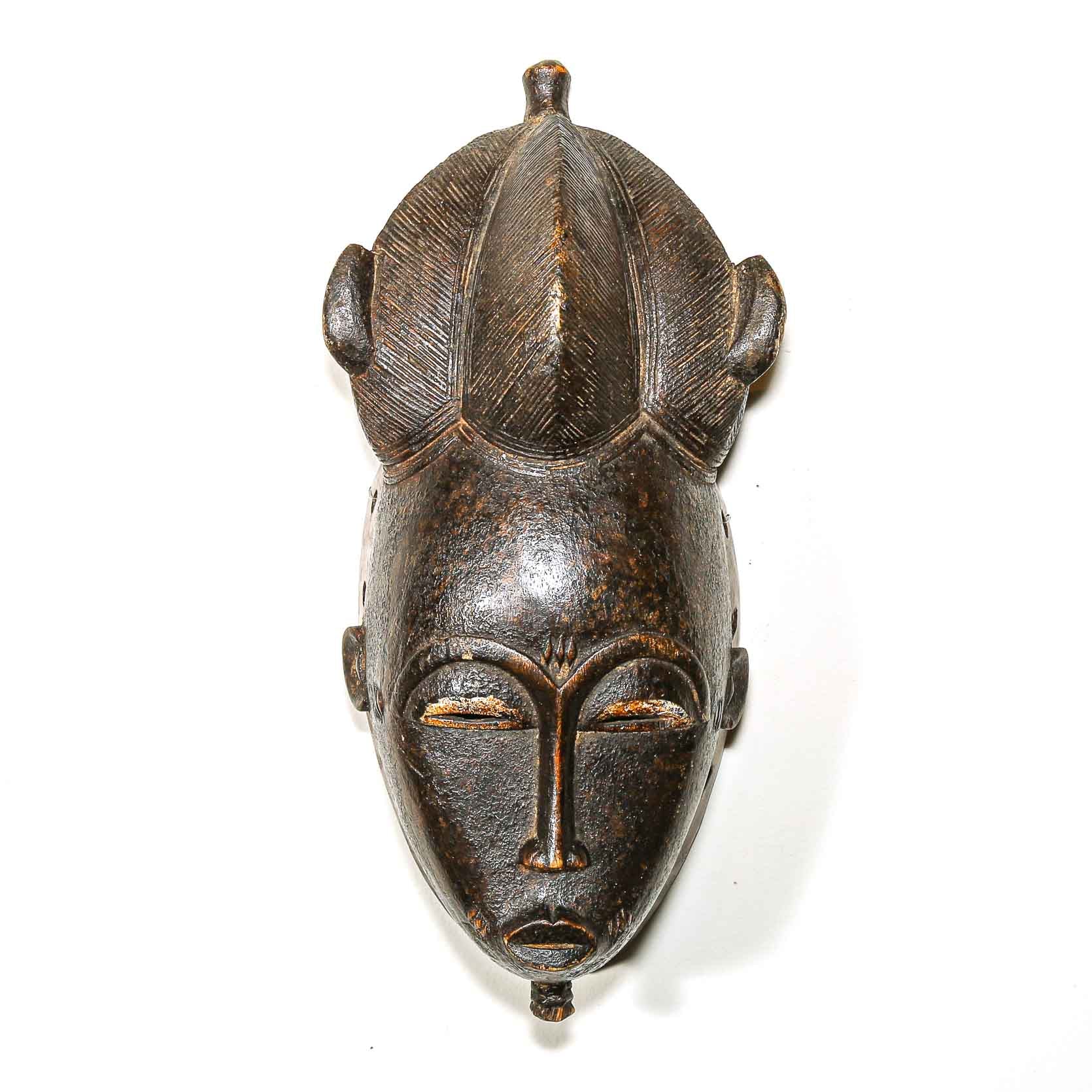 Black African wooden mask on a white background
