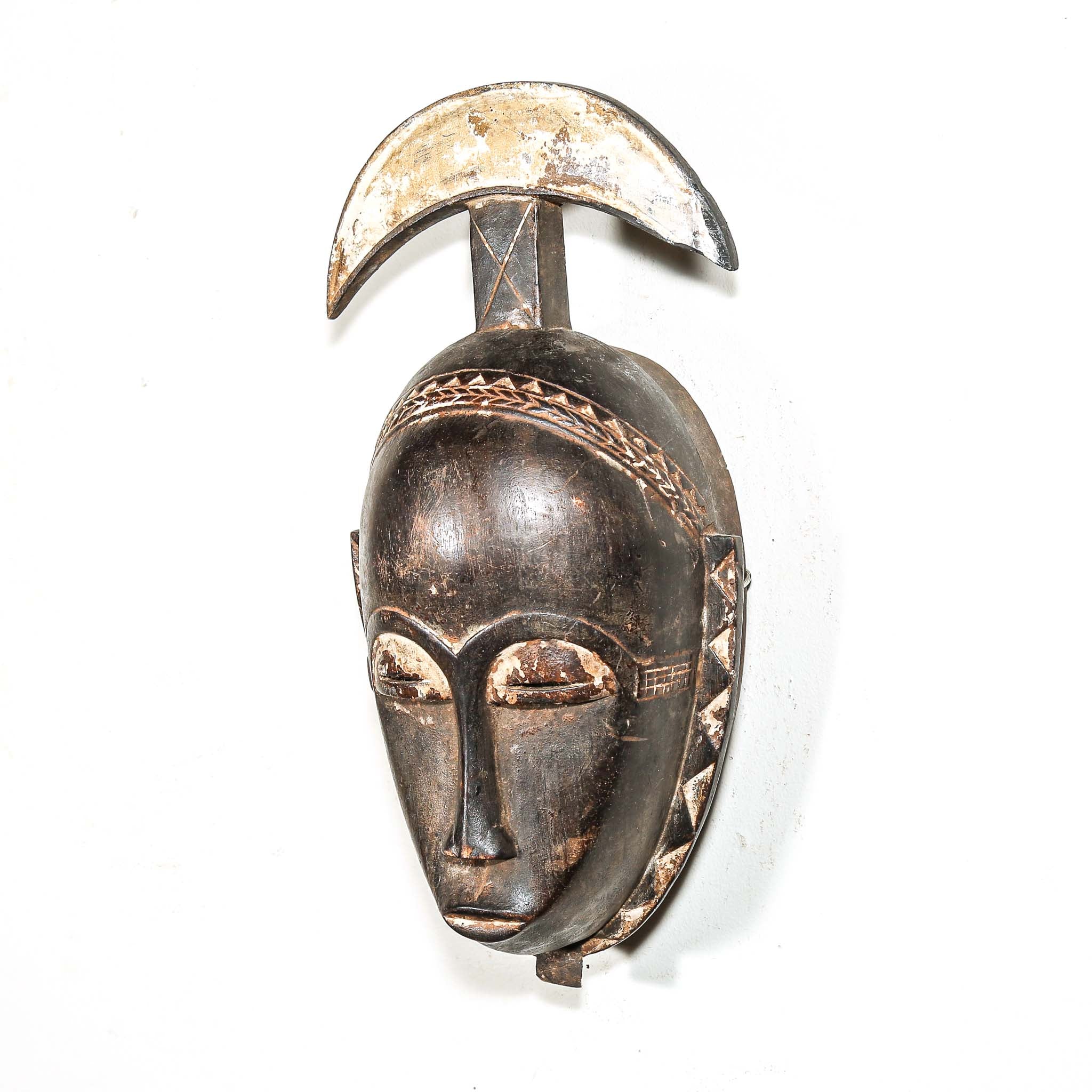 authentic tribal African mask with intricate designs on a white background