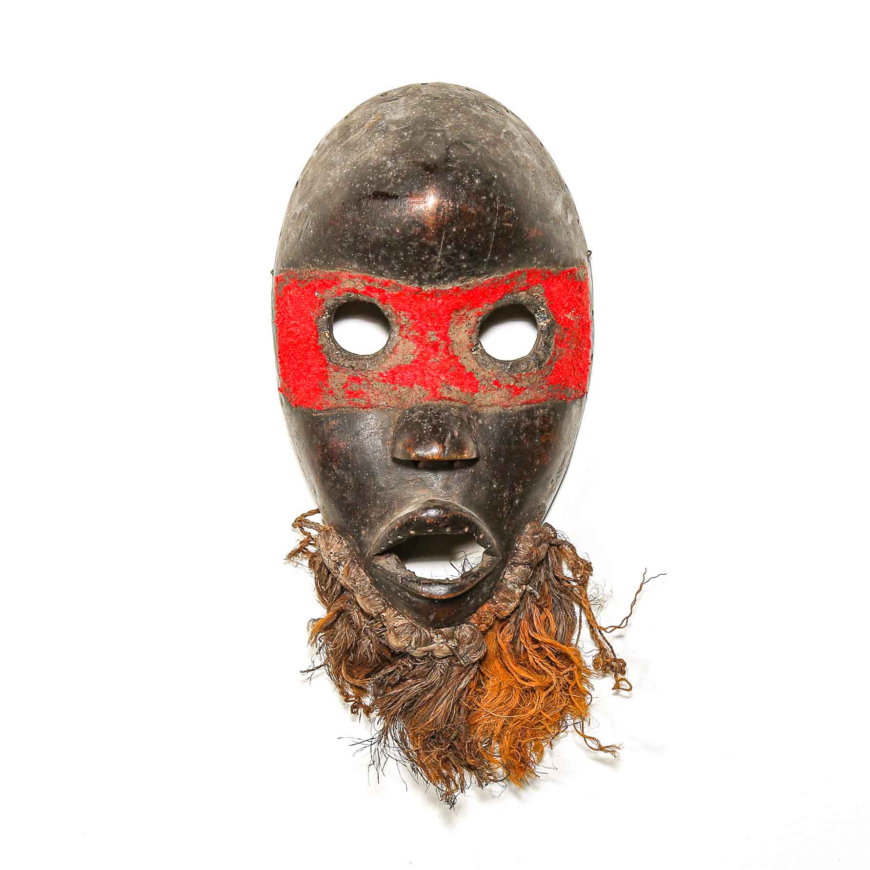 tribal African mask with a red band and brown hair on a white background