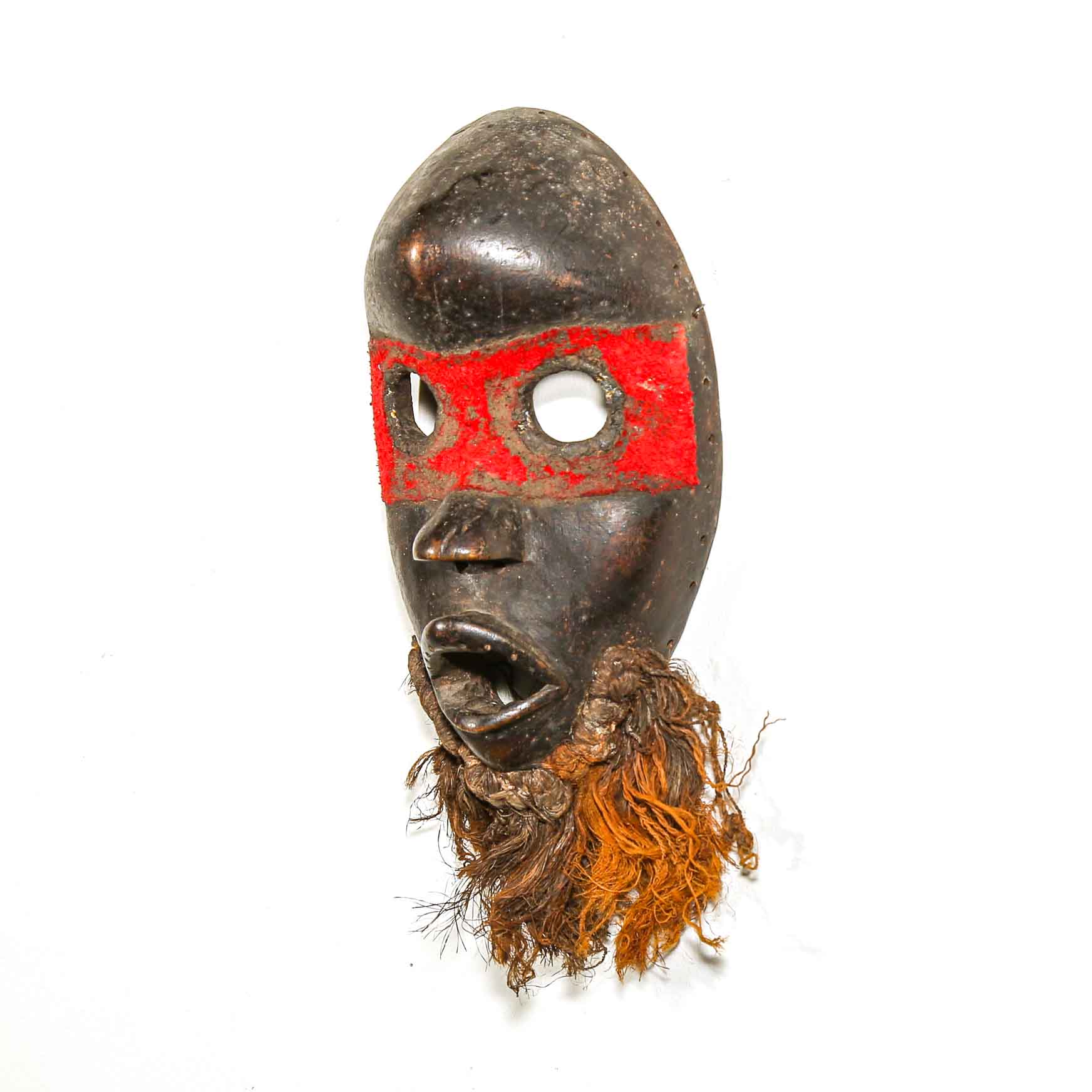 Traditional mask with red face paint and brown hair on a white background