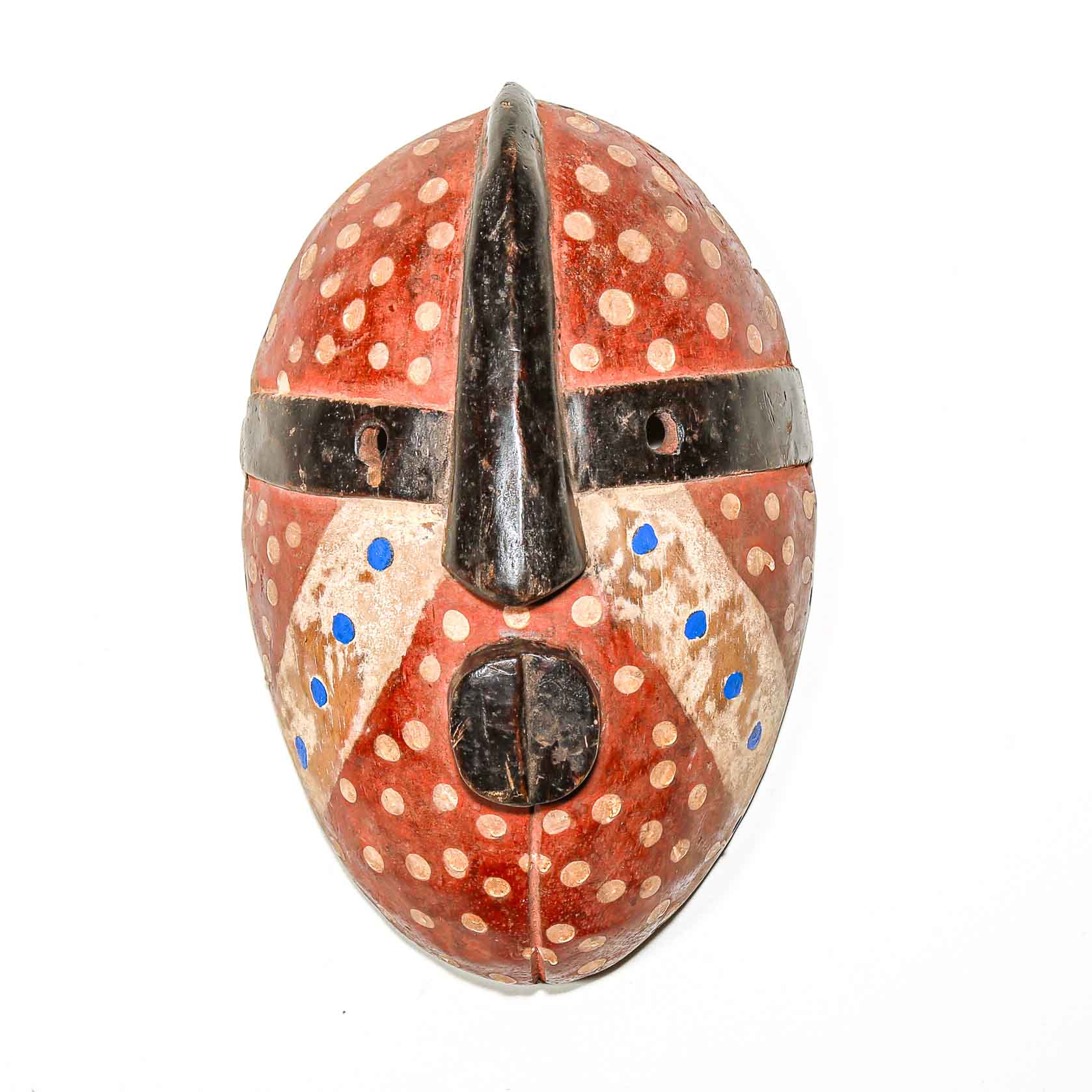 Decorative mask with polka dot pattern on a white background