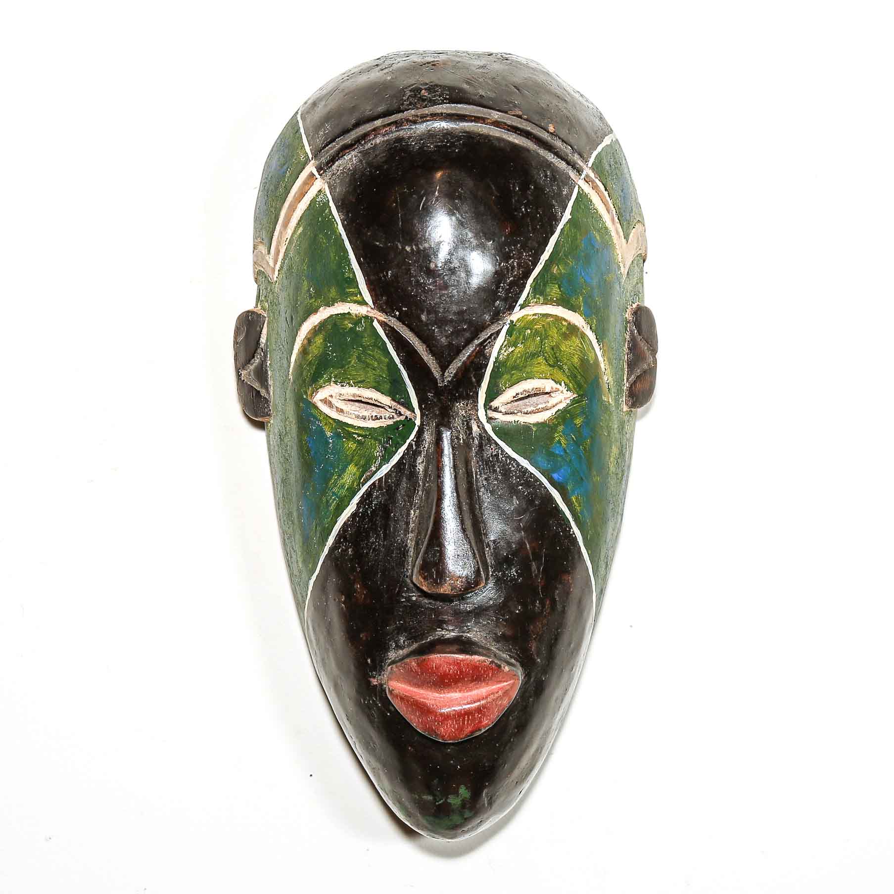 Decorative mask with green, black, and red colors on a white background