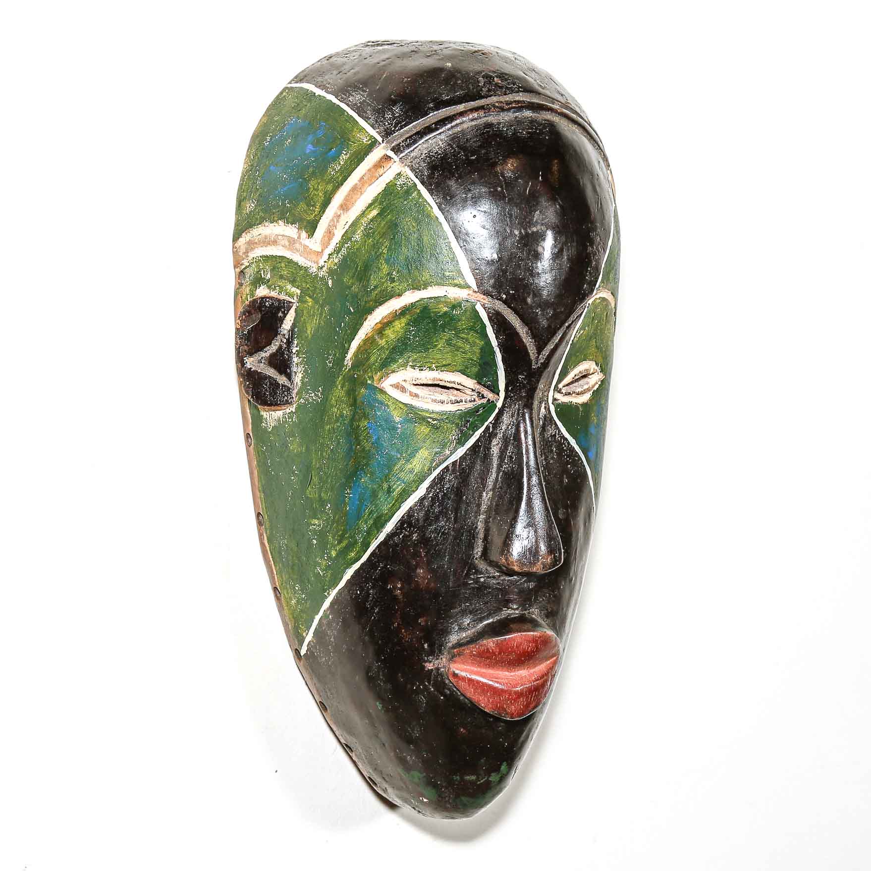 Carved African wooden mask with green and black colors on a white background
