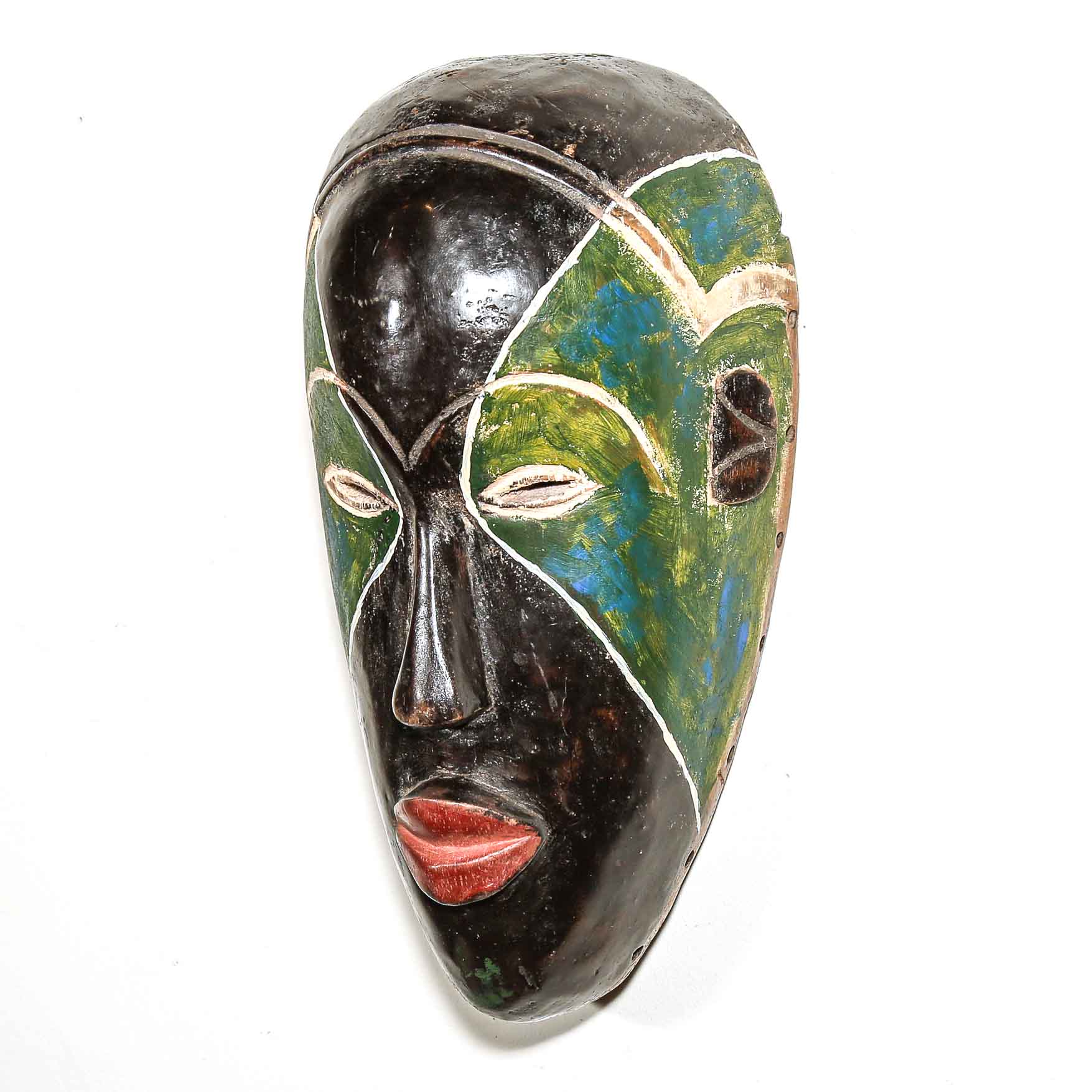 Decorative mask with black, green, and red colors to hang on a white wall
