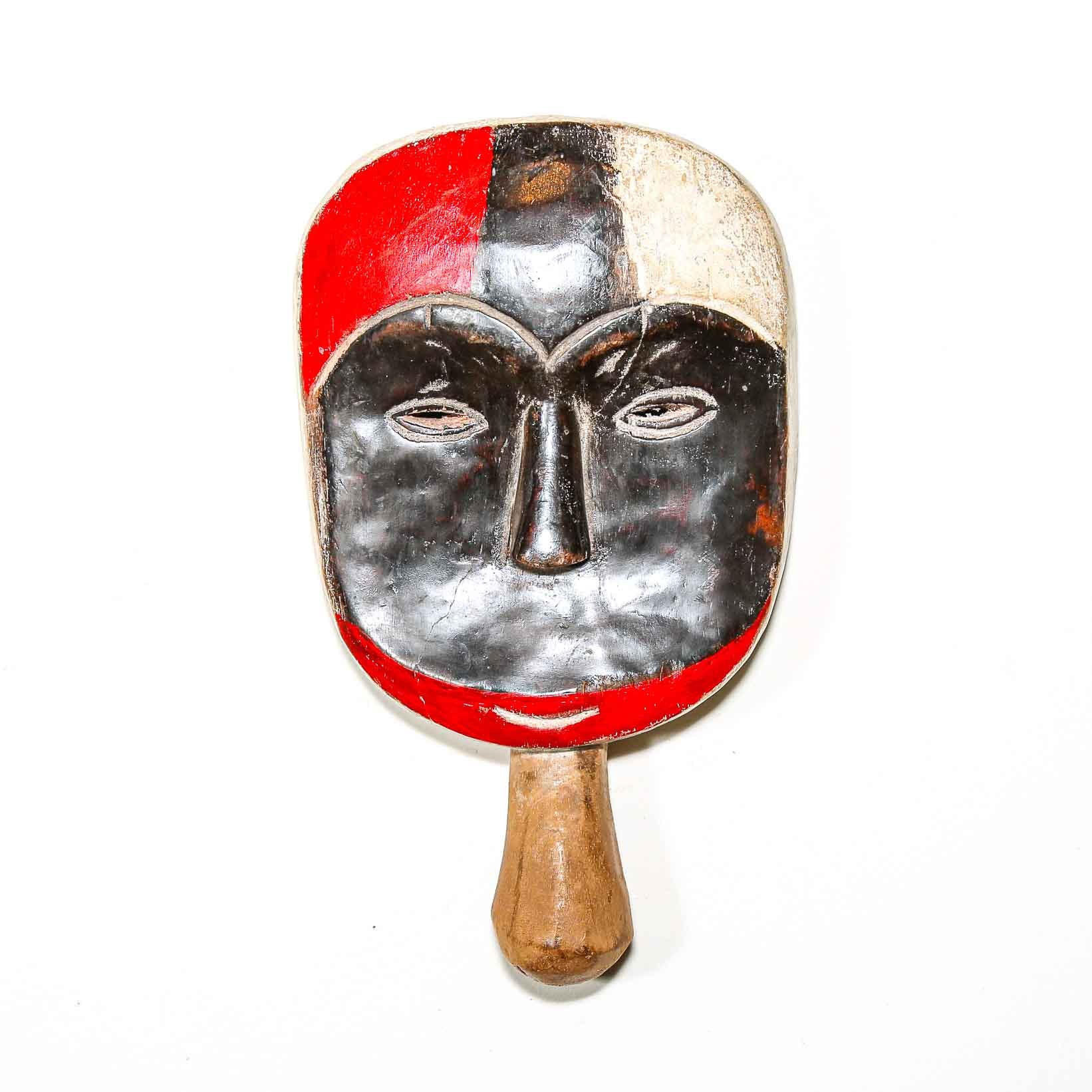 Wooden African mask with red white and black colors on a white background