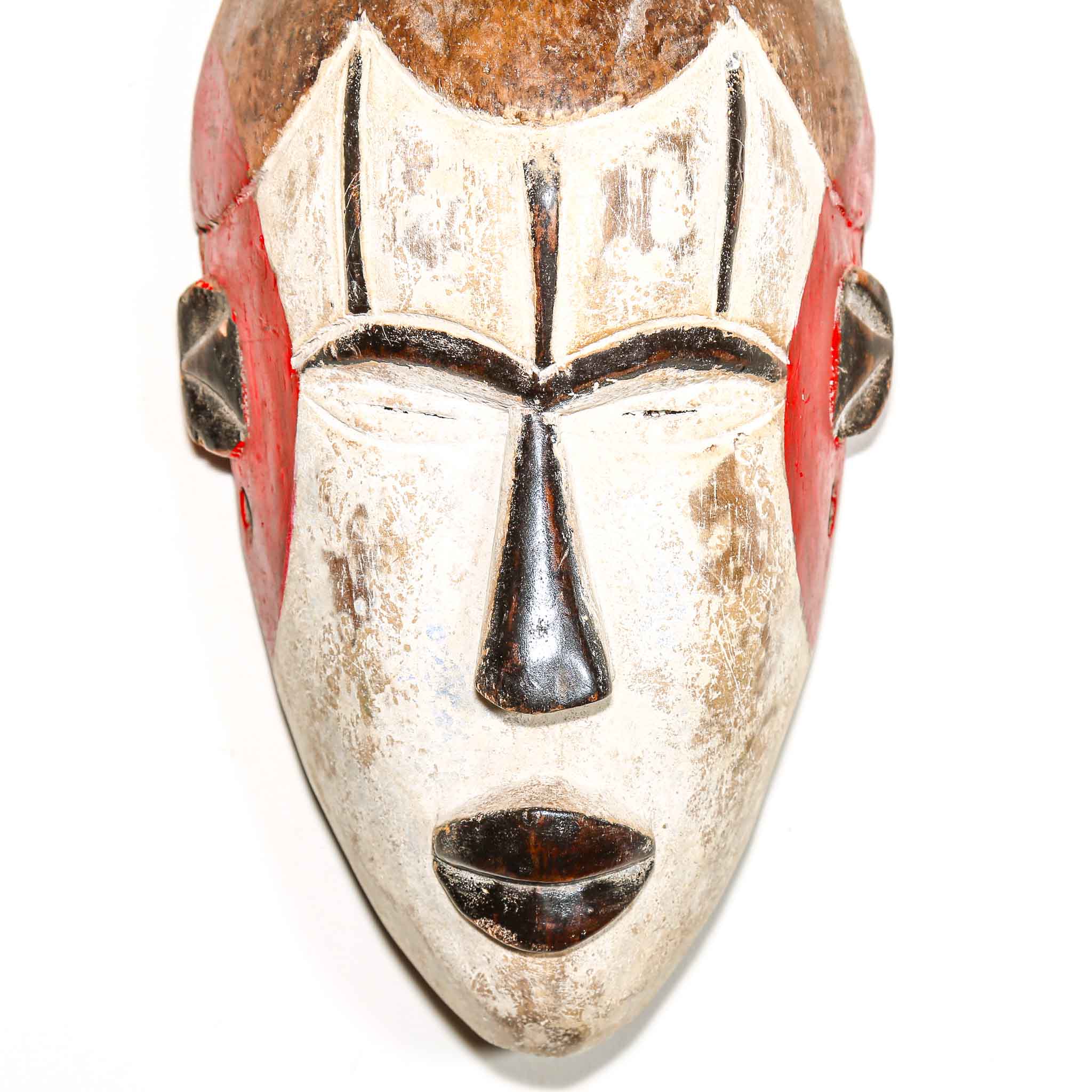 Traditional wooden mask with red accents on a white background
