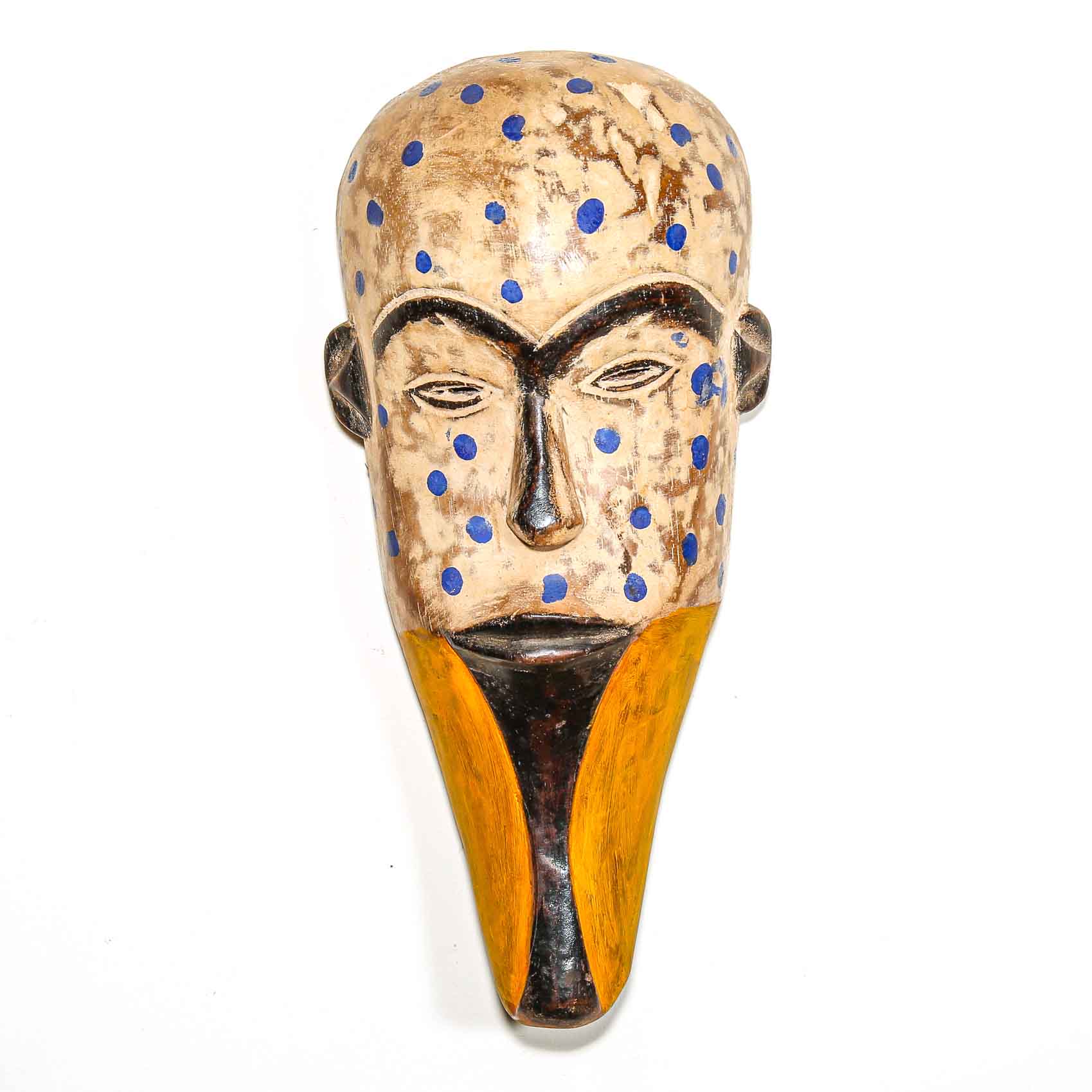 Decorative mask from Africa with blue polka dots and a yellow base on a white background