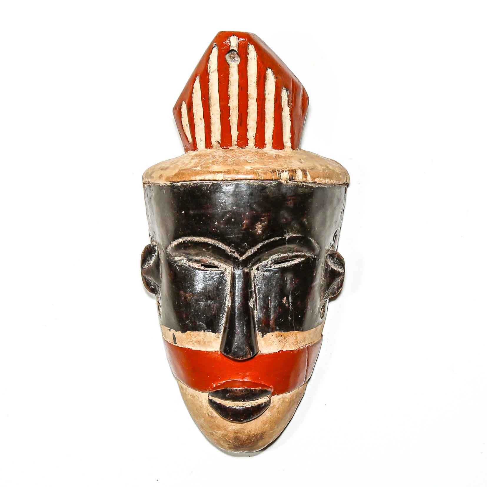 African-style mask with red, black, and beige colors on a white background