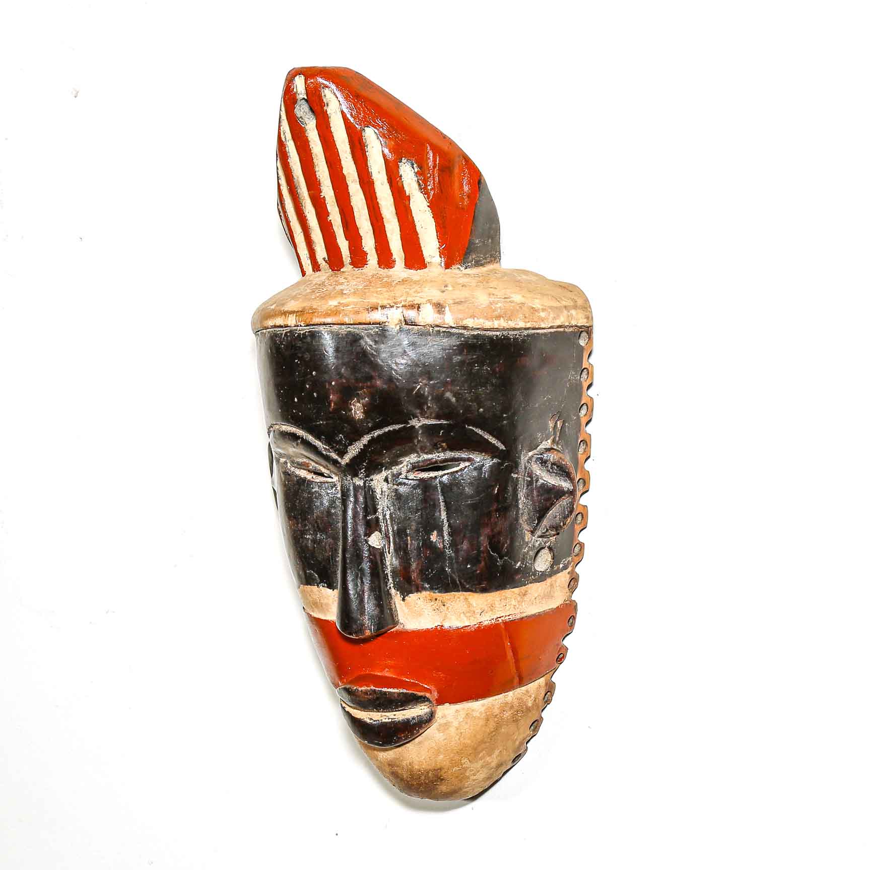 African mask that hangs on the wall with red, black, and gold colors on a white background