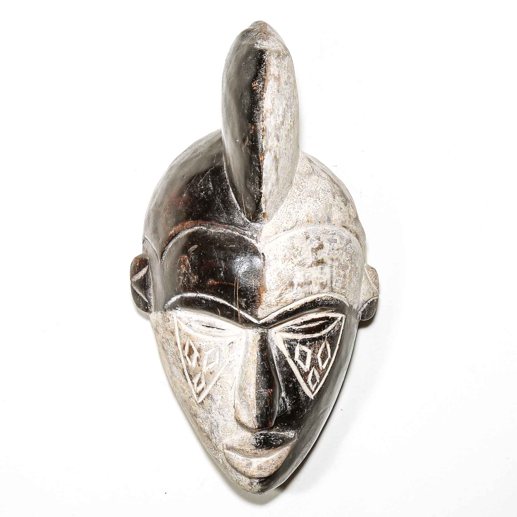 black and white African mask on a white background