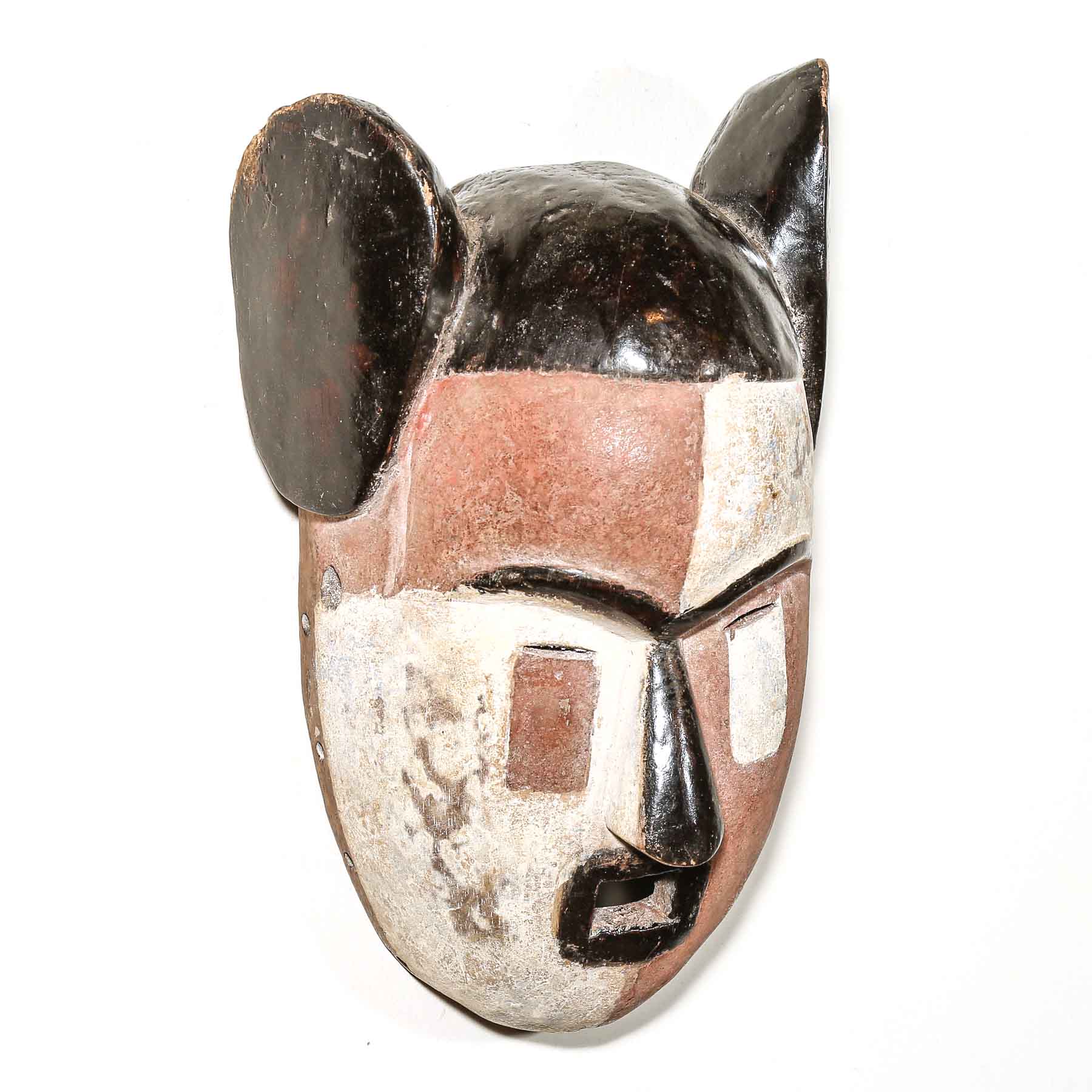 carved African mask on a bedroom wall

