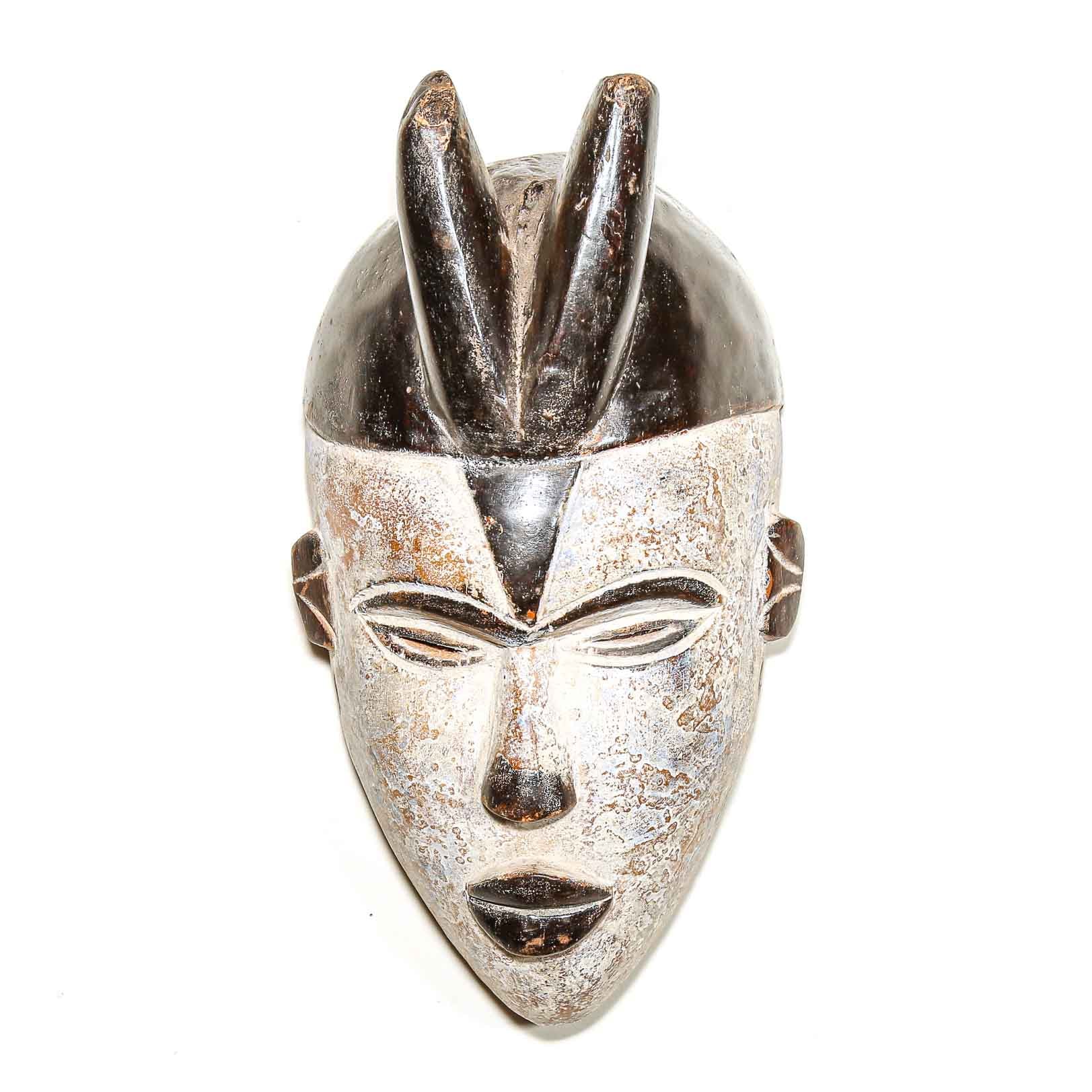black and white African mask with a face design on a white background