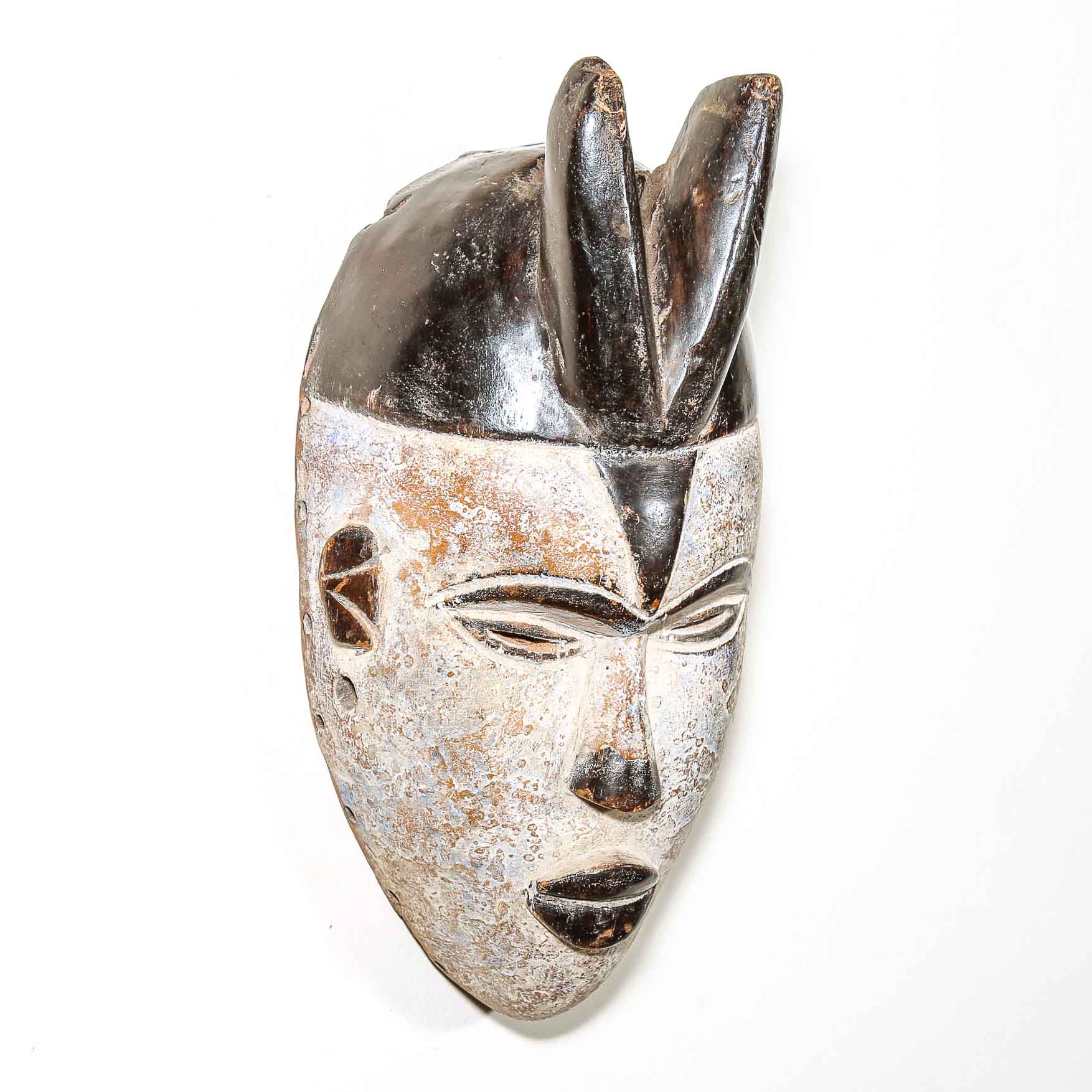 African mask with a white background